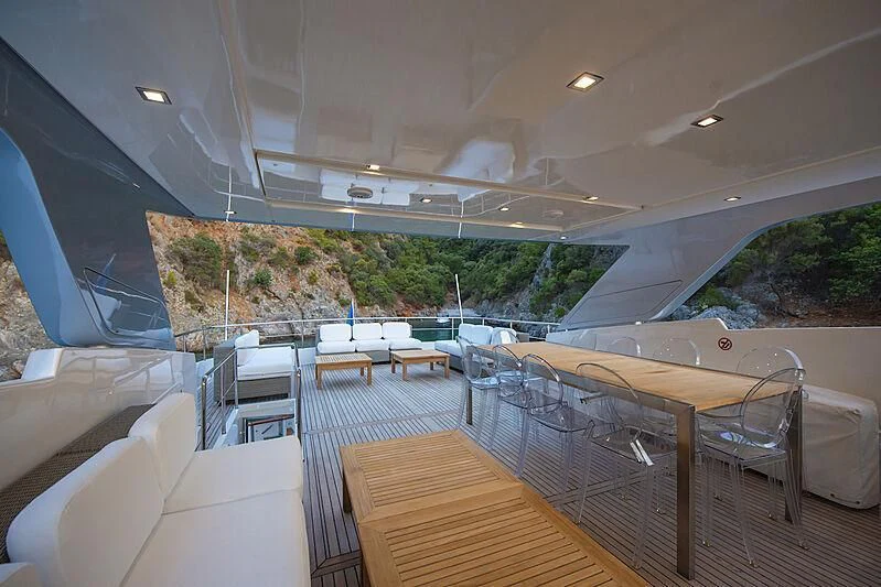 a deck with a large pool and trees on the side aboard LADY EMESA Yacht for Sale