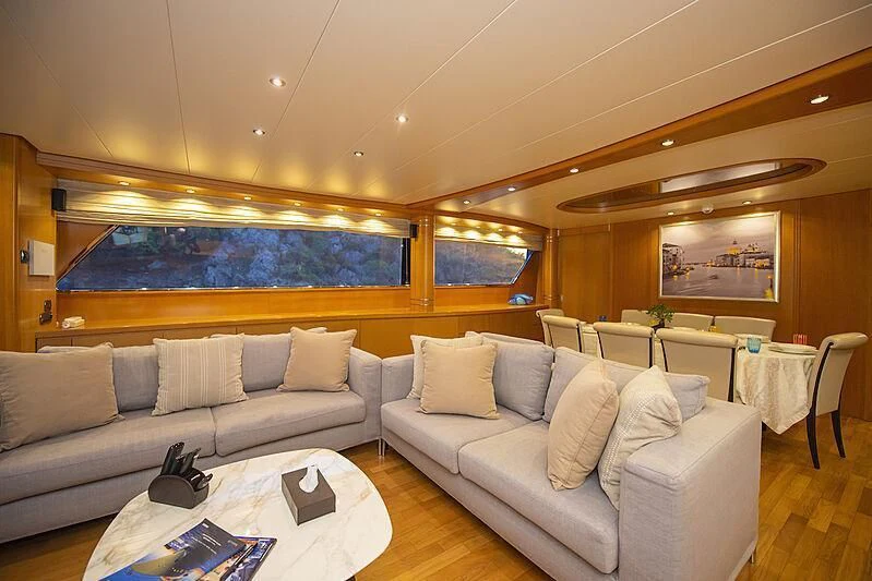 a living room with a couch and a table aboard LADY EMESA Yacht for Sale