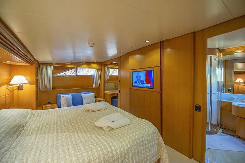 a hotel room with a bed and a tv aboard LADY EMESA Yacht for Sale