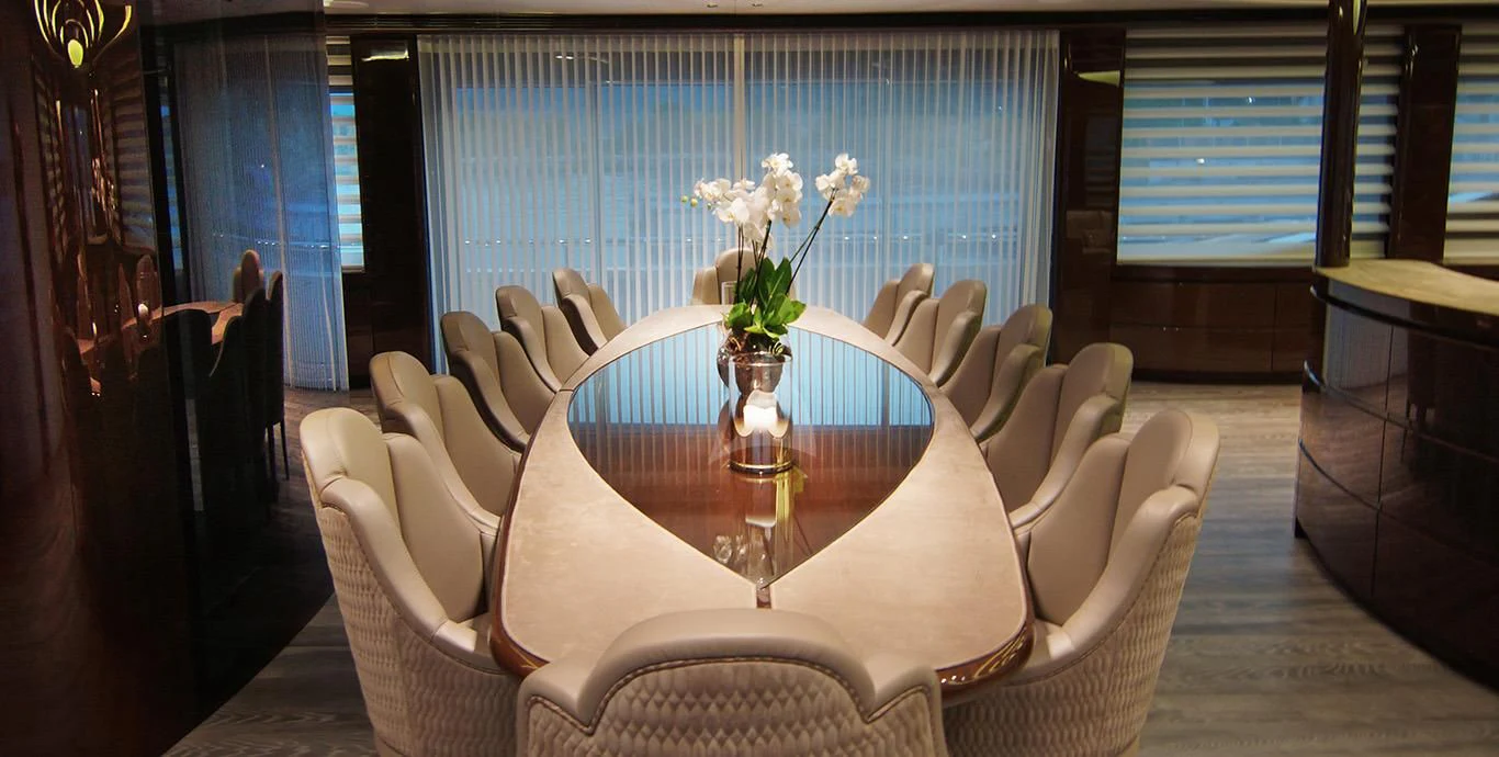a table with white flowers on it aboard BABA'S Yacht for Sale