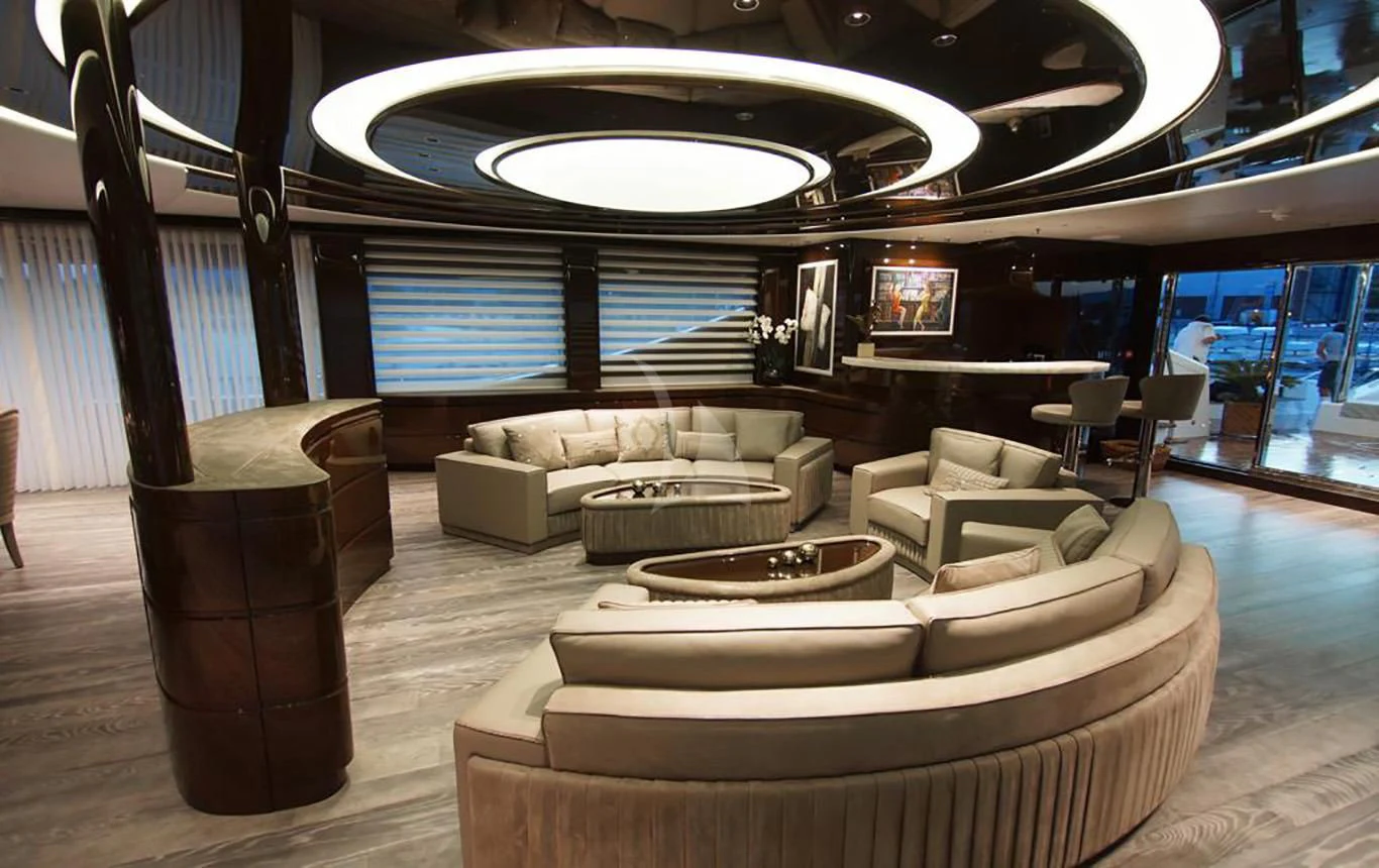 a room with couches and a large round table aboard BABA'S Yacht for Sale