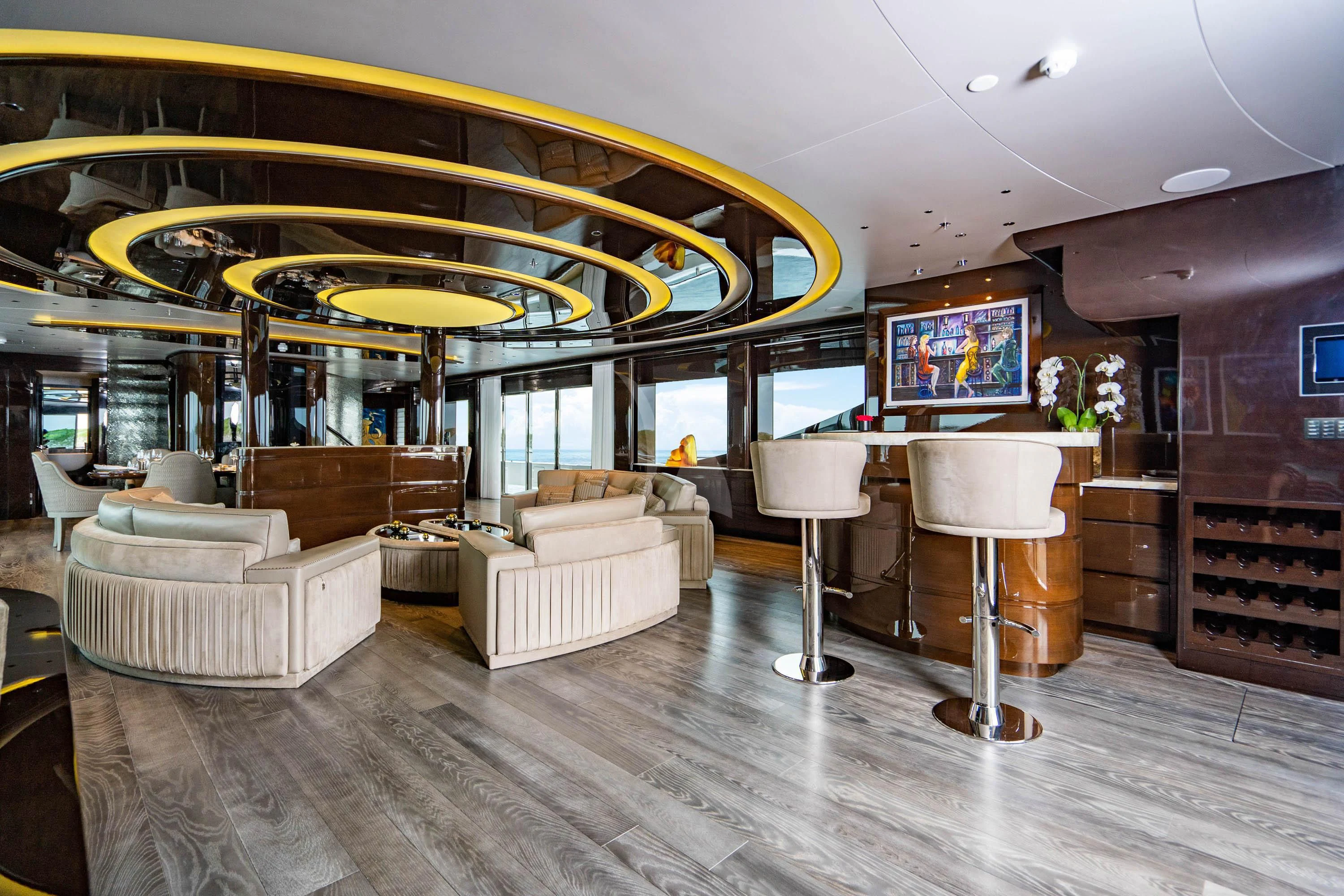 a room with a couch and a table and chairs aboard BABA'S Yacht for Sale