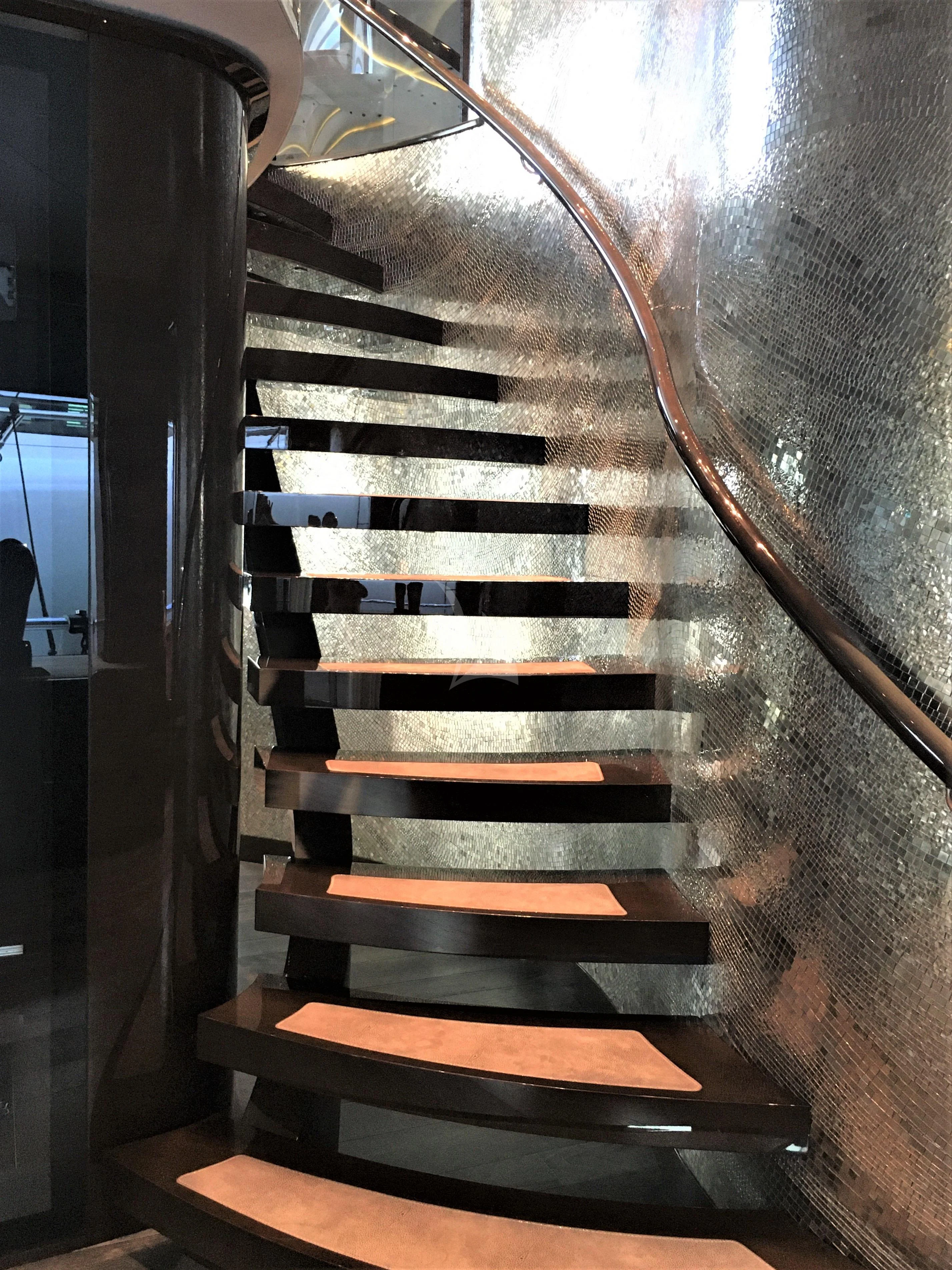 a black and white striped staircase aboard BABA'S Yacht for Sale