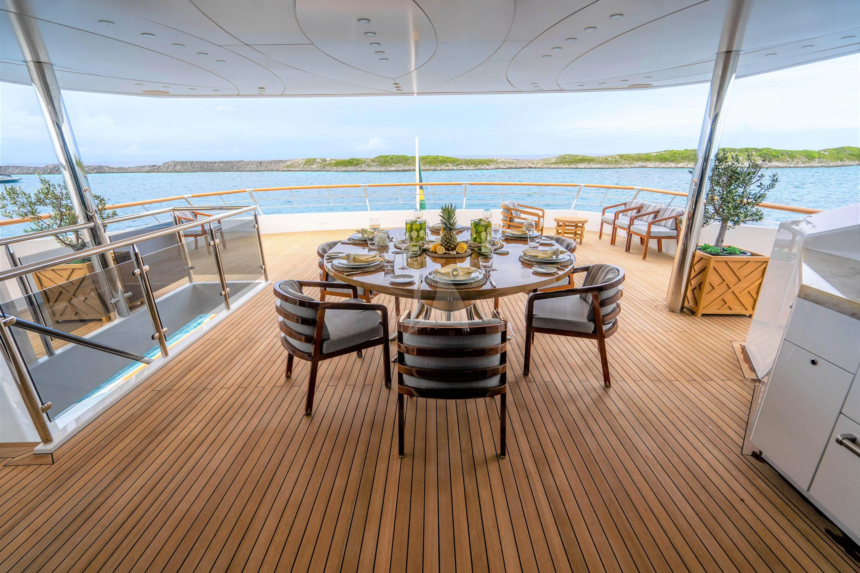a table on a deck aboard BABA'S Yacht for Sale