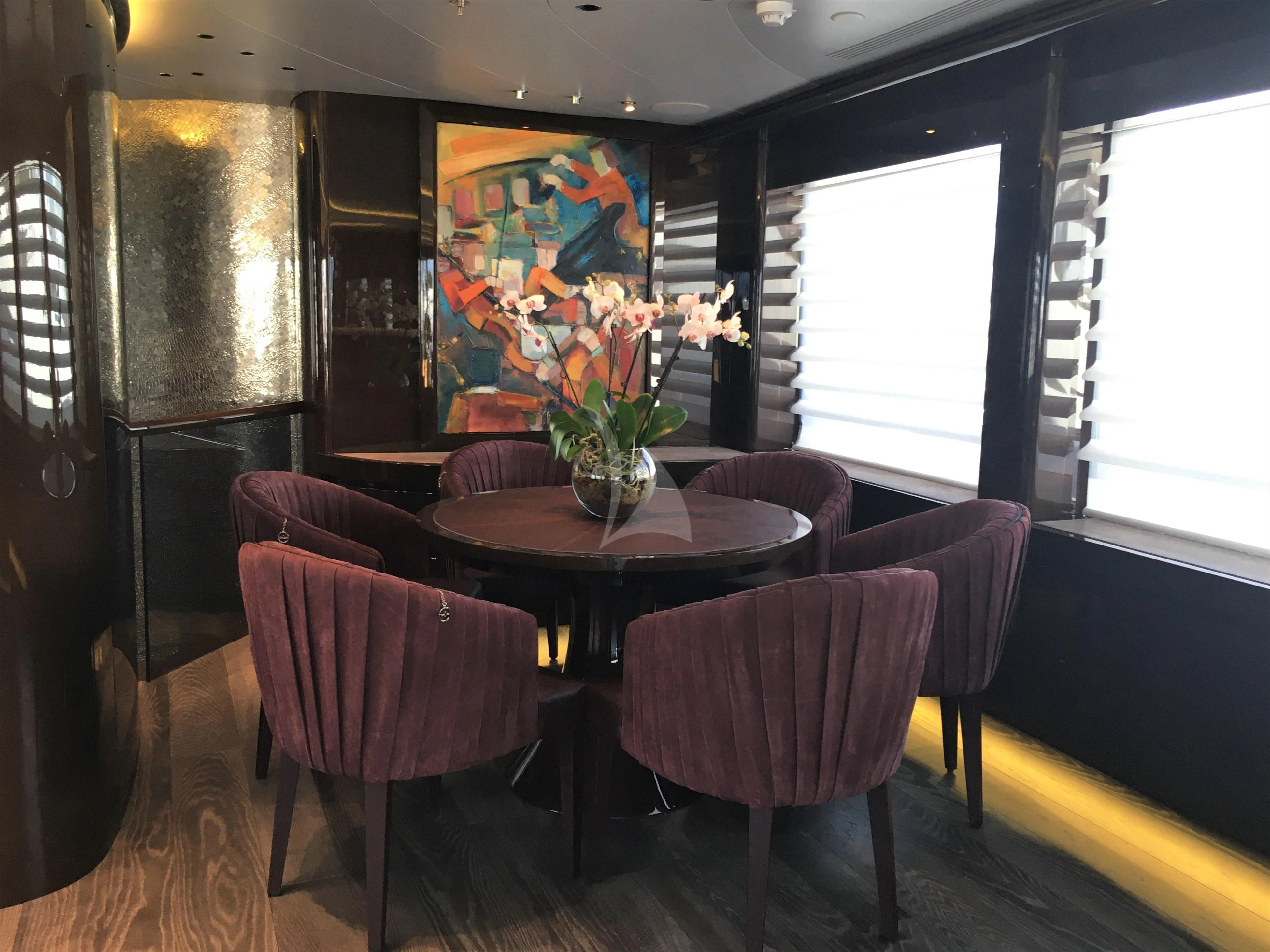 a room with a table and chairs aboard BABA'S Yacht for Sale