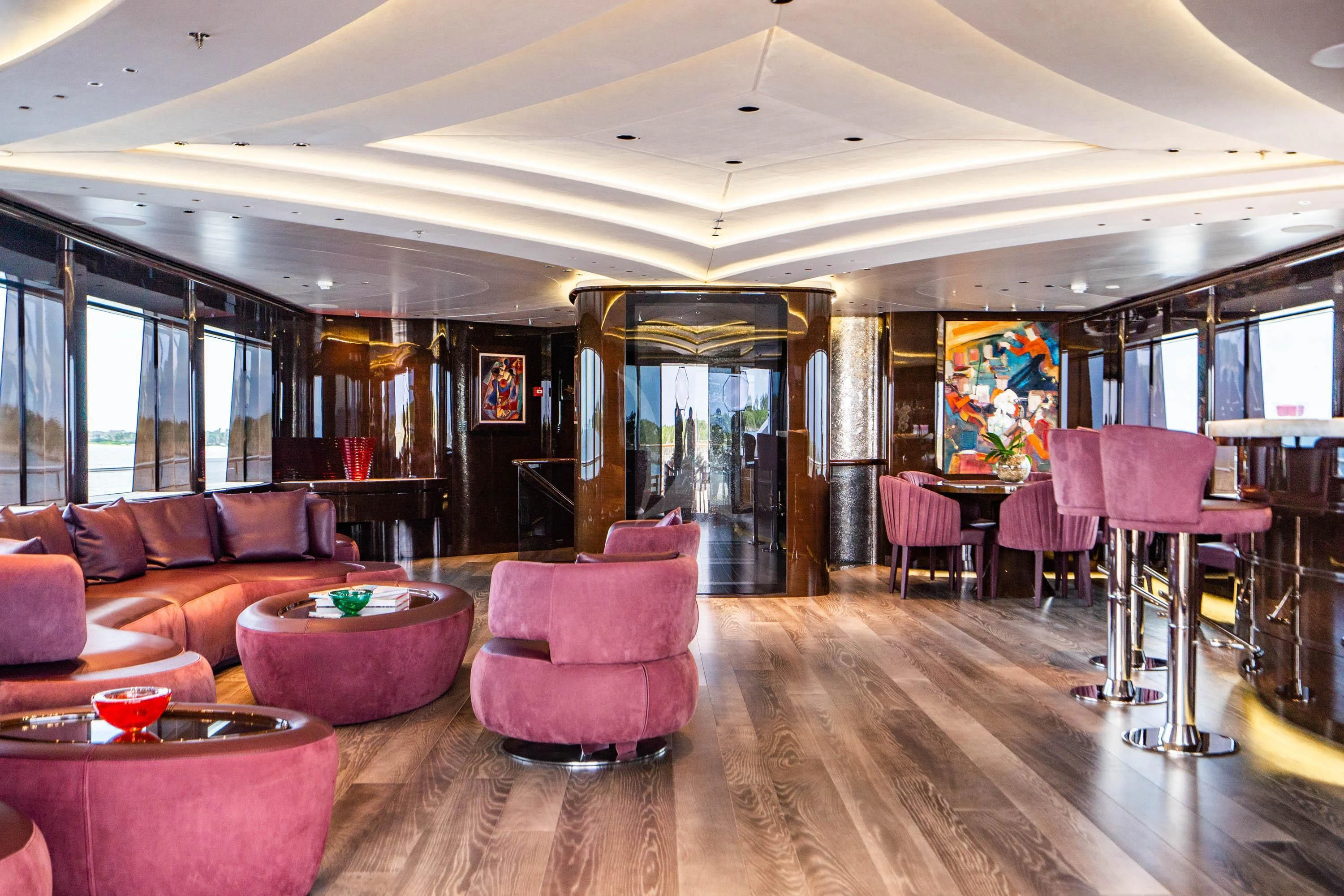 a room with a wood floor and pink chairs and a wood floor aboard BABA'S Yacht for Sale