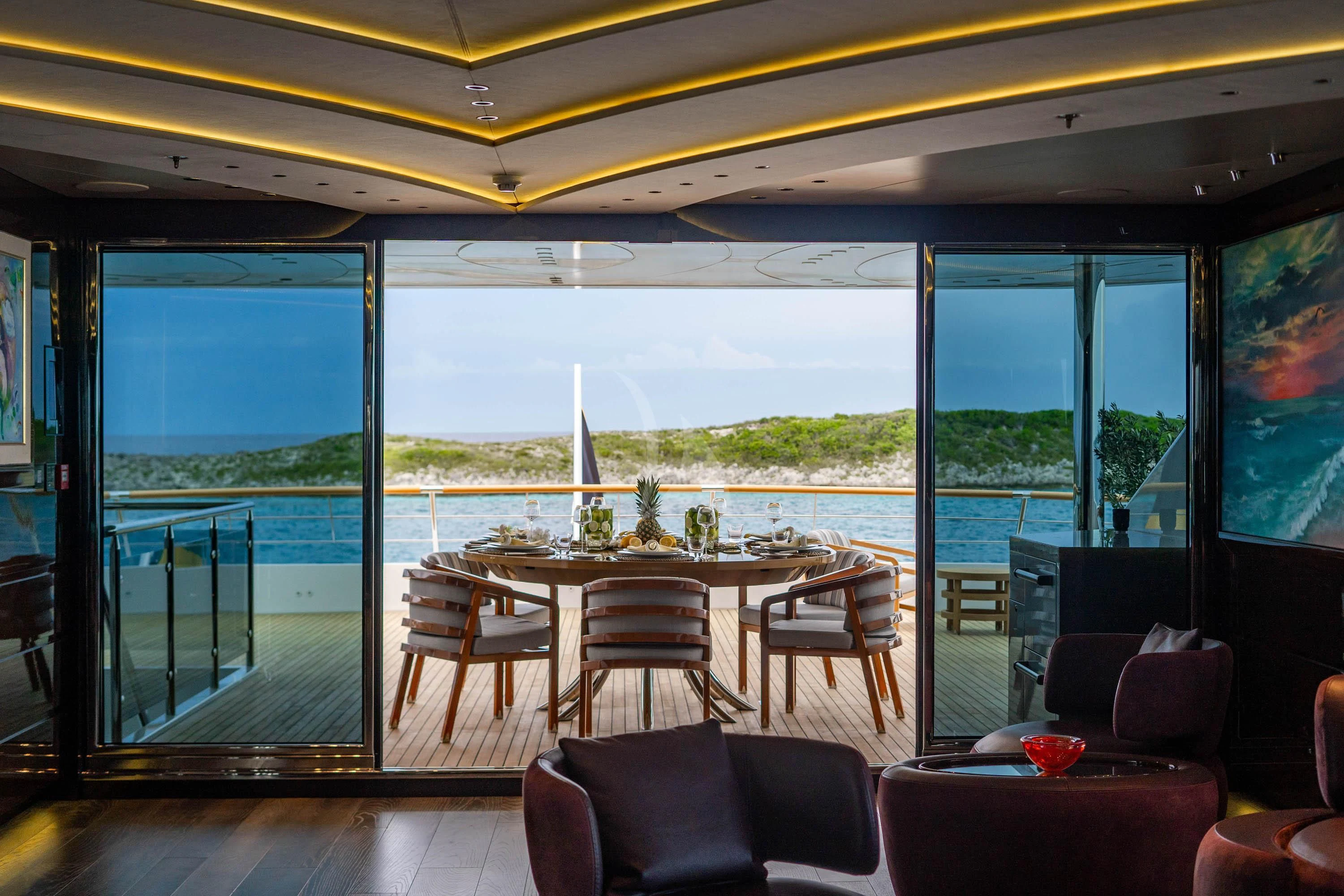 a room with a table and chairs aboard BABA'S Yacht for Sale