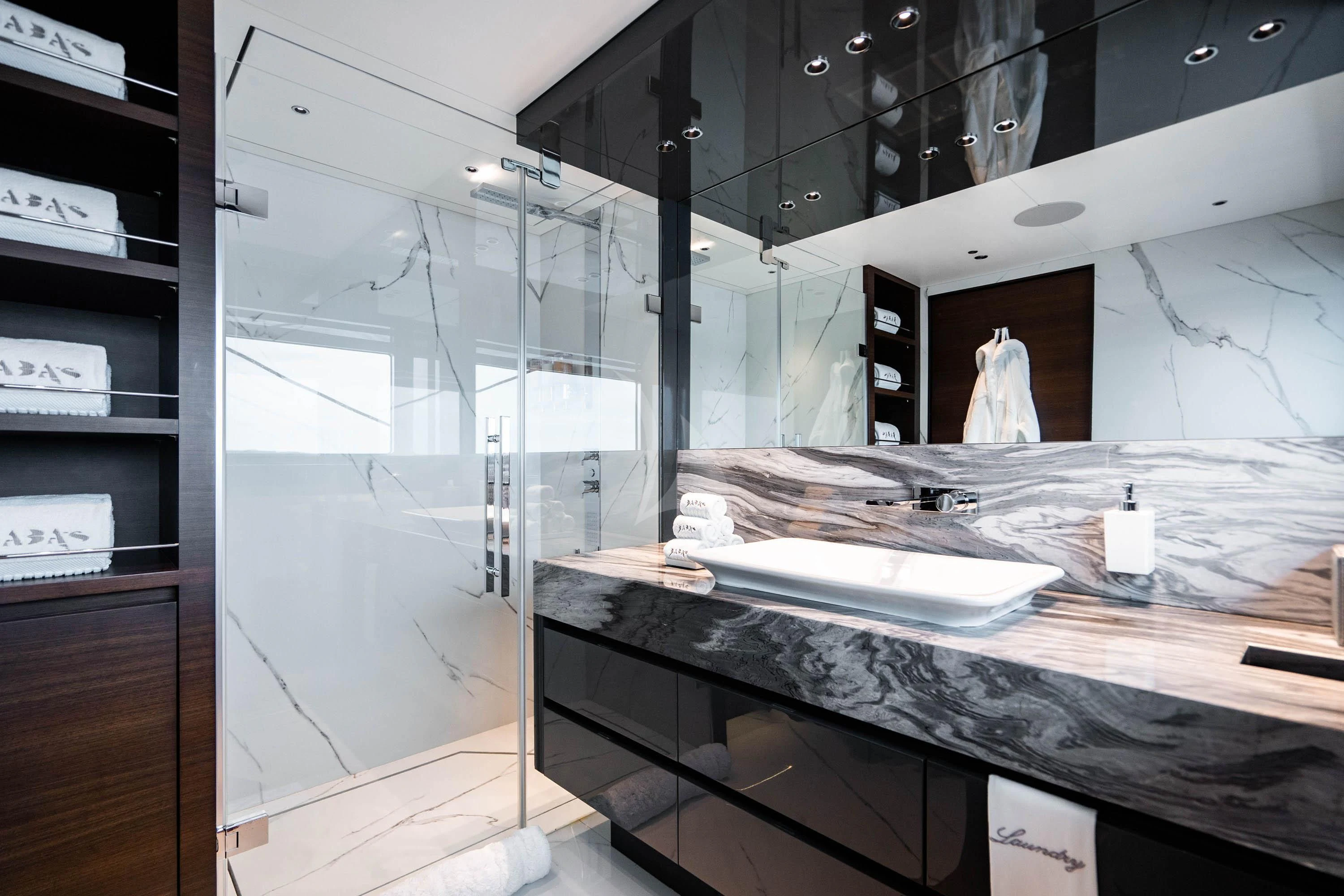 a large bathroom with glass walls aboard BABA'S Yacht for Sale