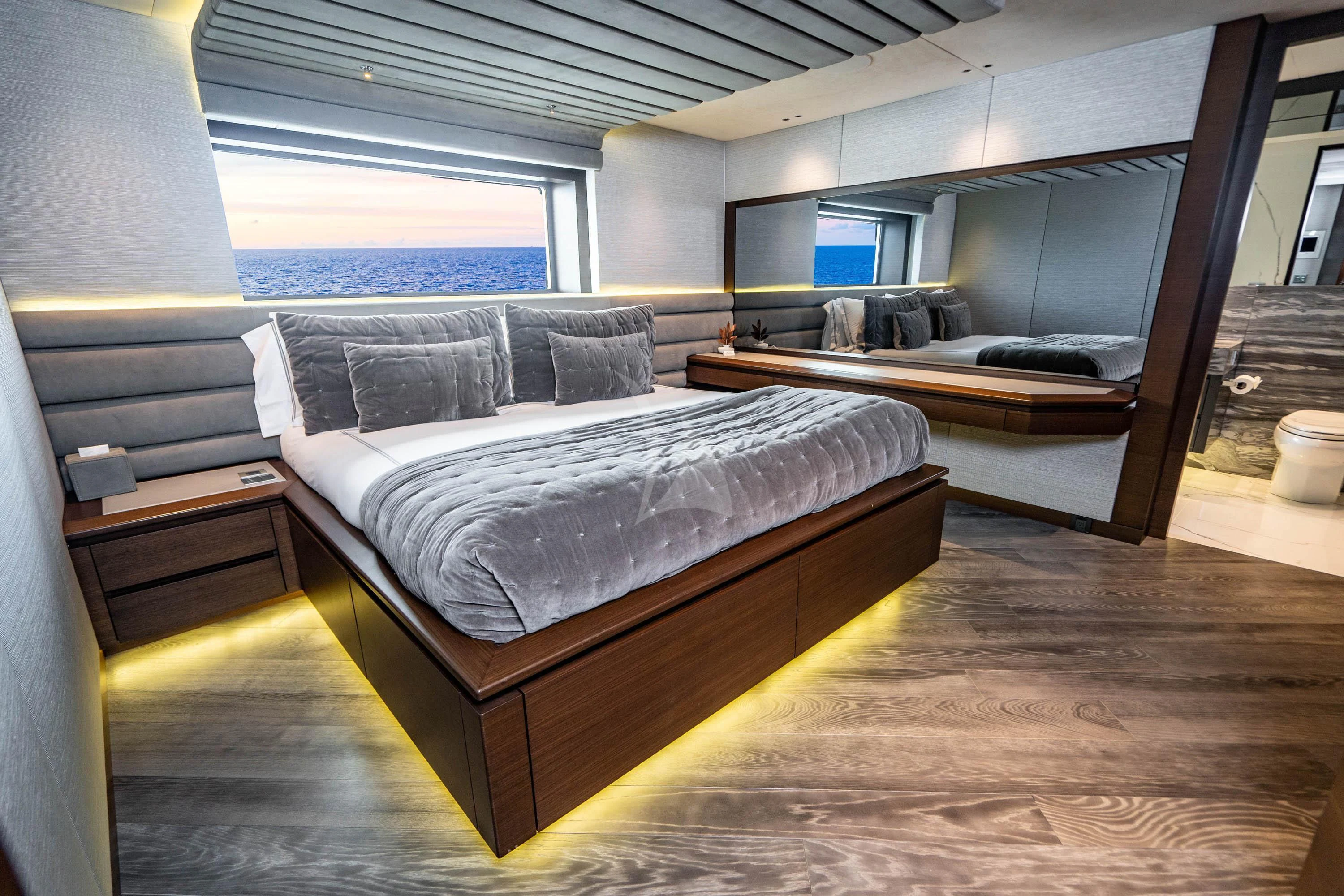a room with a bed and a wood floor aboard BABA'S Yacht for Sale