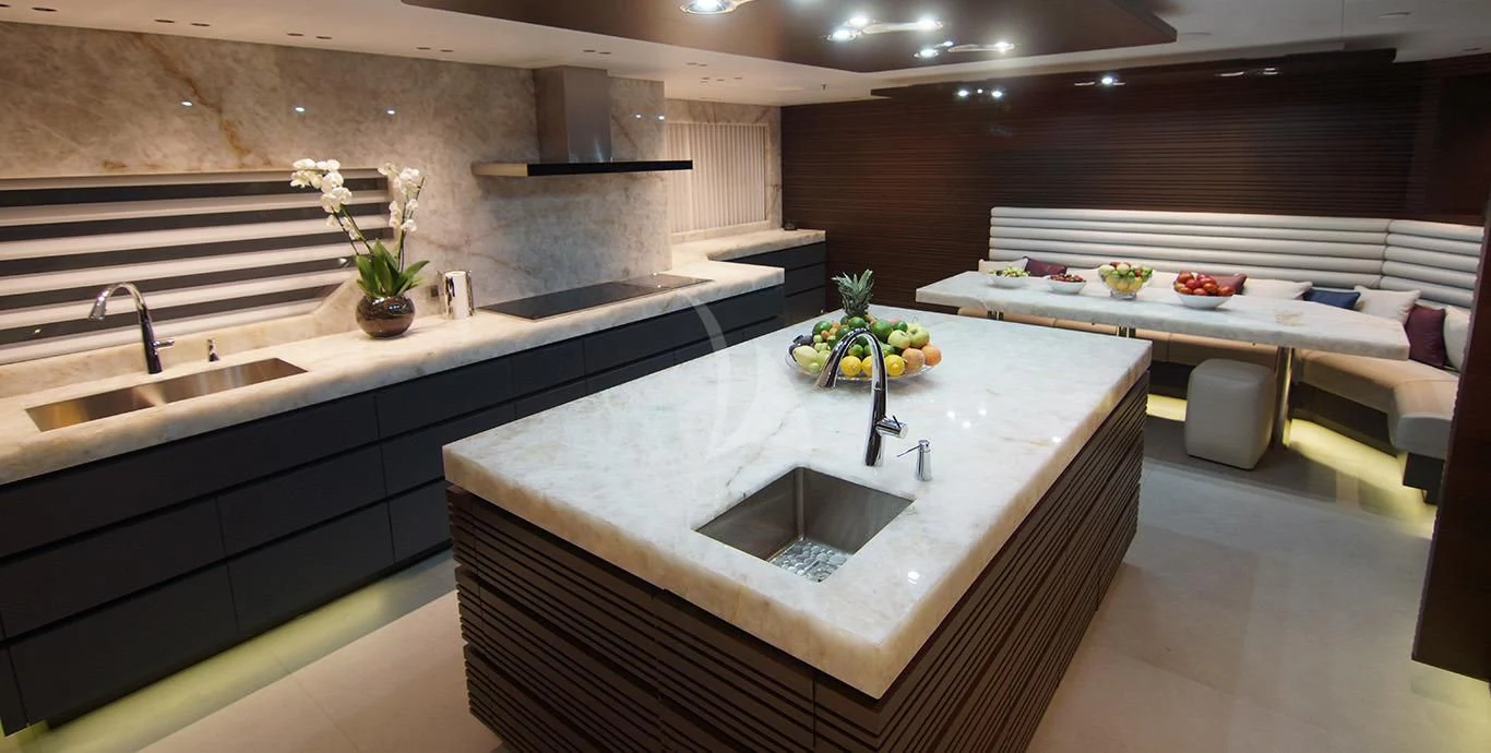 a kitchen with a countertop sink and cabinets aboard BABA'S Yacht for Sale