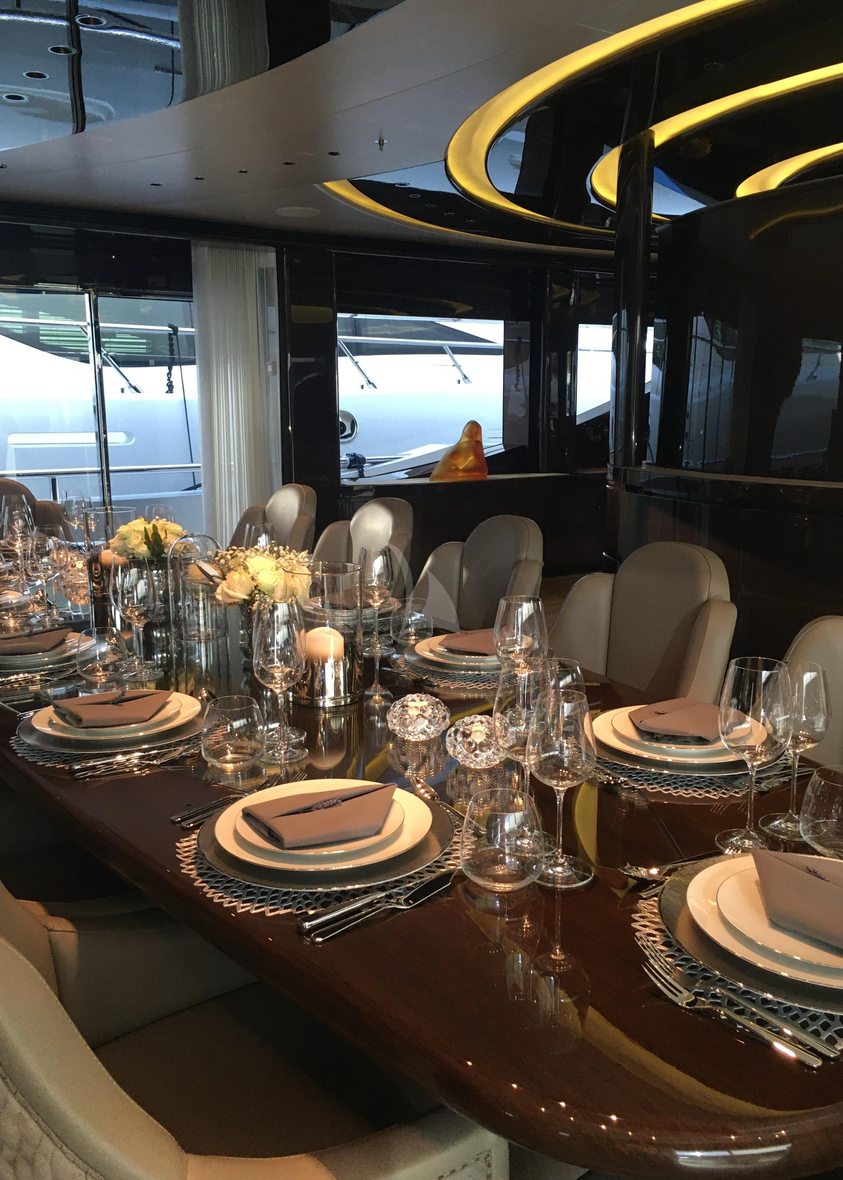 a table with plates and glasses aboard BABA'S Yacht for Sale