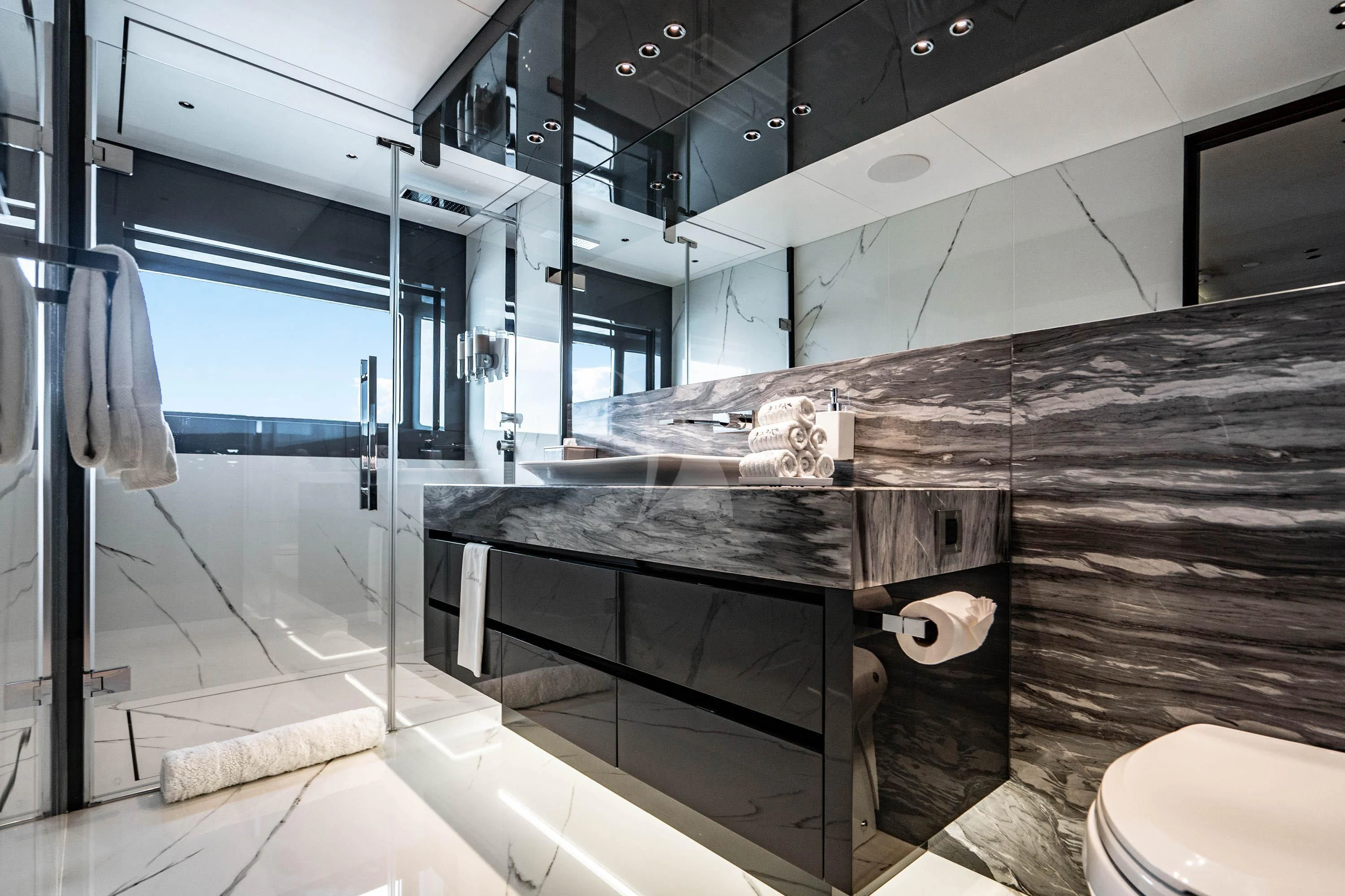 a bathroom with a glass shower aboard BABA'S Yacht for Sale