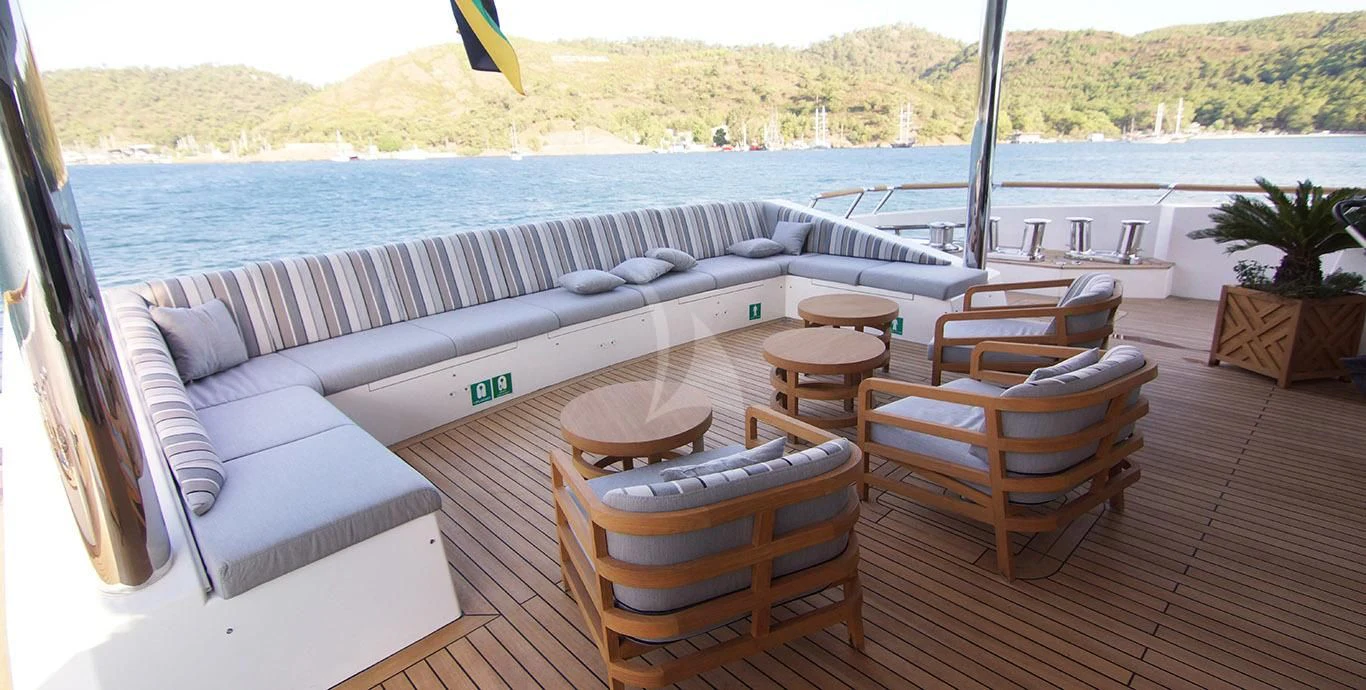 a deck with a couch and chairs on it aboard BABA'S Yacht for Sale