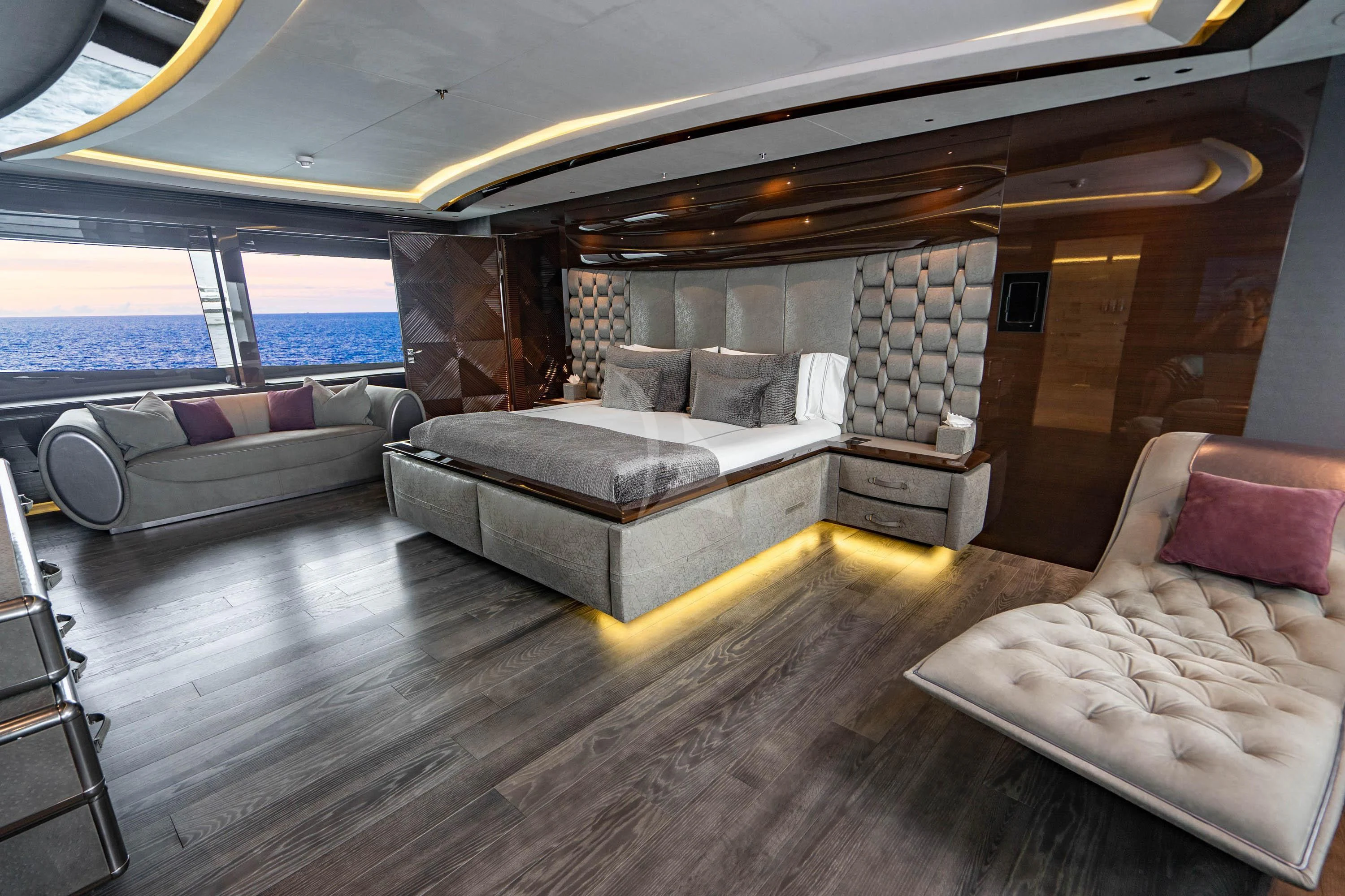 a living room with a couch and a large window aboard BABA'S Yacht for Sale