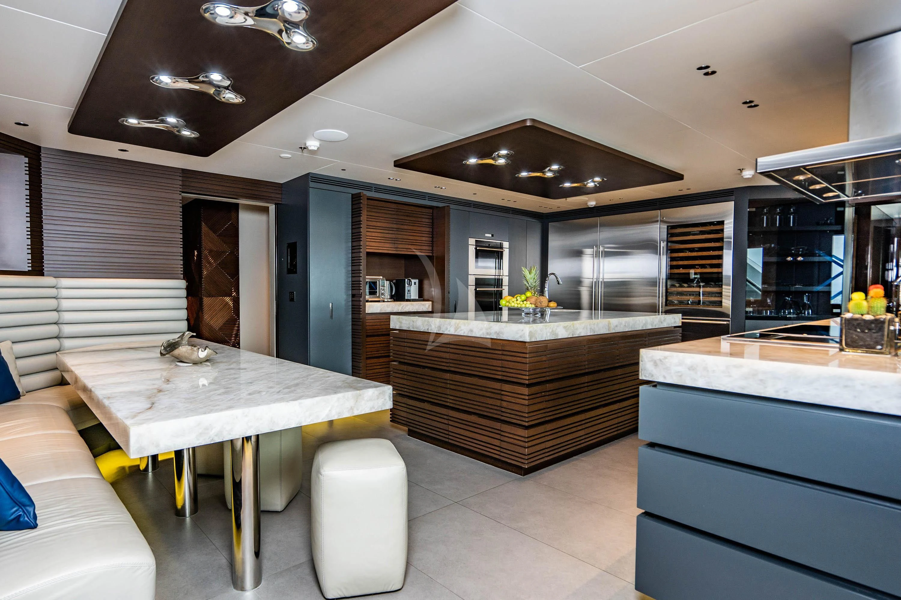 a modern kitchen with a large island aboard BABA'S Yacht for Sale