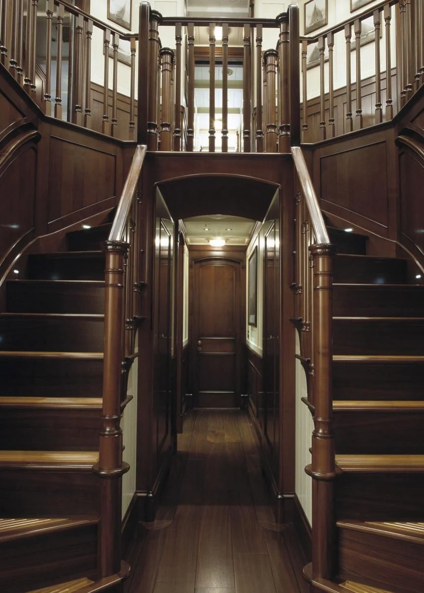 a wooden staircase in a building aboard BYSTANDER Yacht for Sale