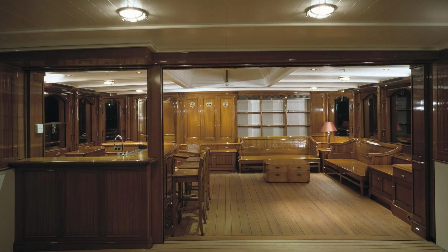 a large room with wooden furniture aboard BYSTANDER Yacht for Sale