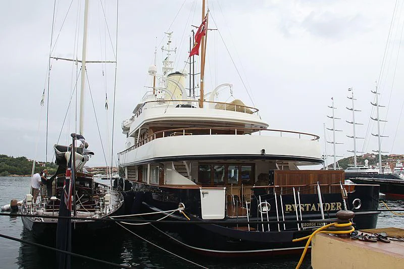a boat docked at a pier aboard BYSTANDER Yacht for Sale