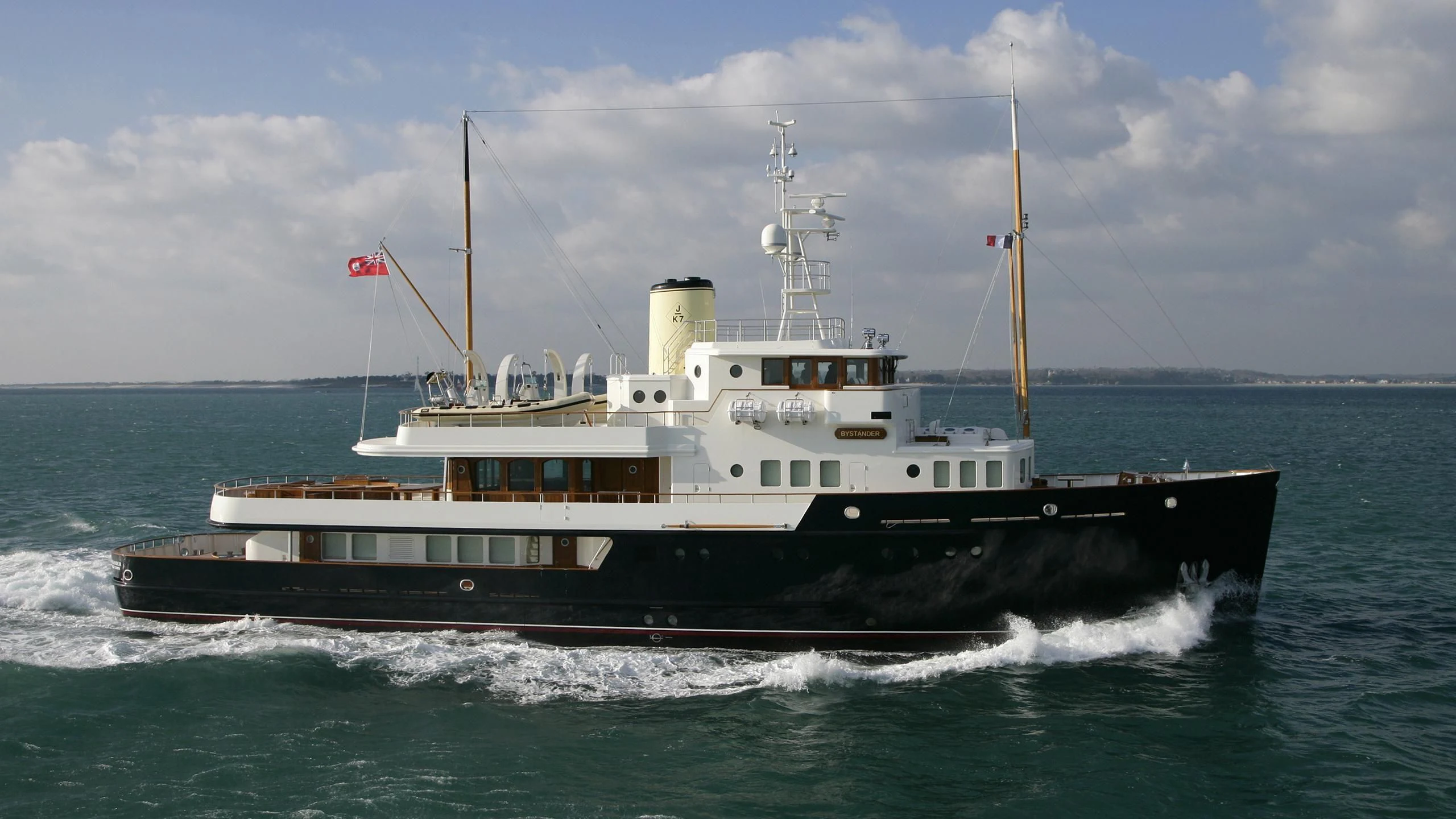 a large ship in the water aboard BYSTANDER Yacht for Sale