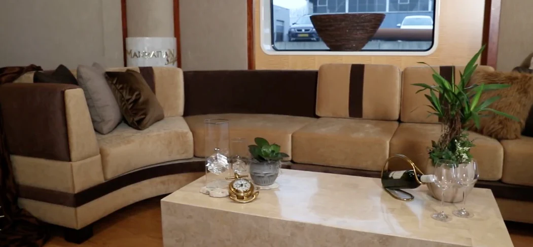 a living room with a couch and coffee table aboard ANNA J Yacht for Sale