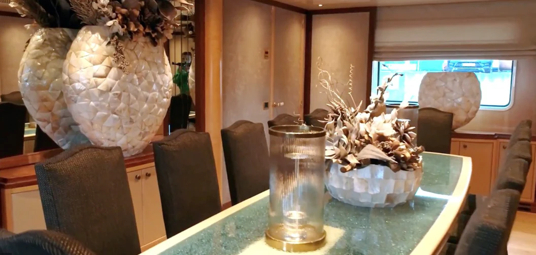 a vase of flowers on a table aboard ANNA J Yacht for Sale