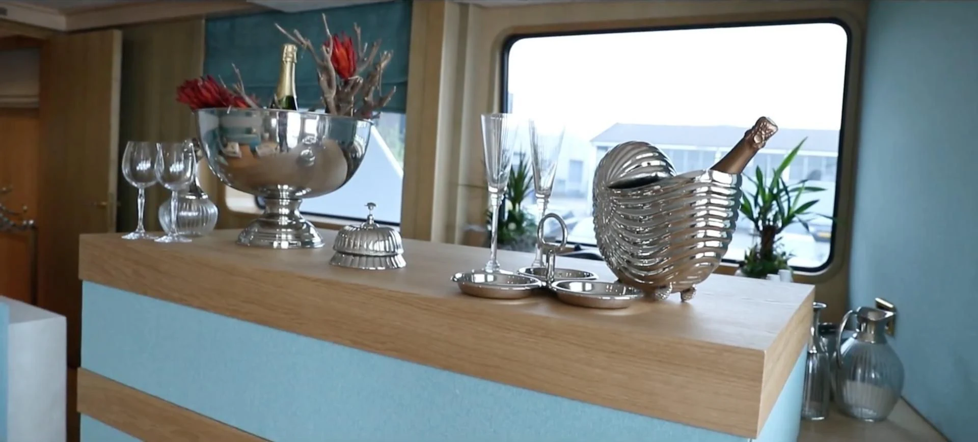a table with a vase and a basket with flowers in it aboard ANNA J Yacht for Sale