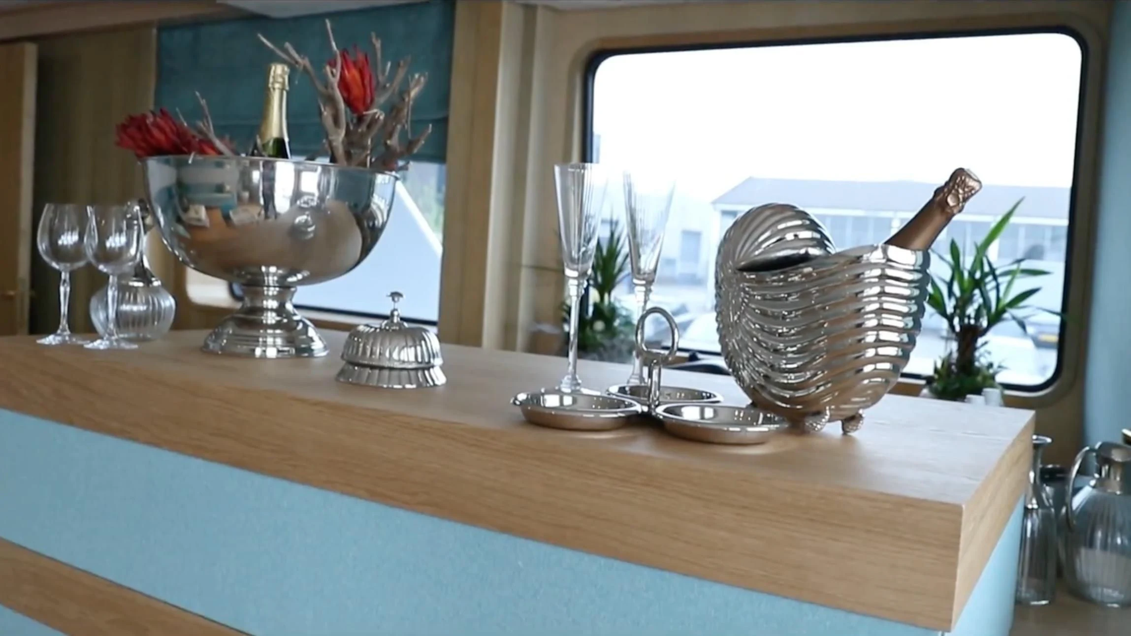 a table with a vase and glasses aboard ANNA J Yacht for Sale
