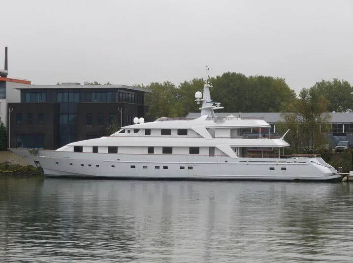 a large white boat in a harbor aboard ANNA J Yacht for Sale