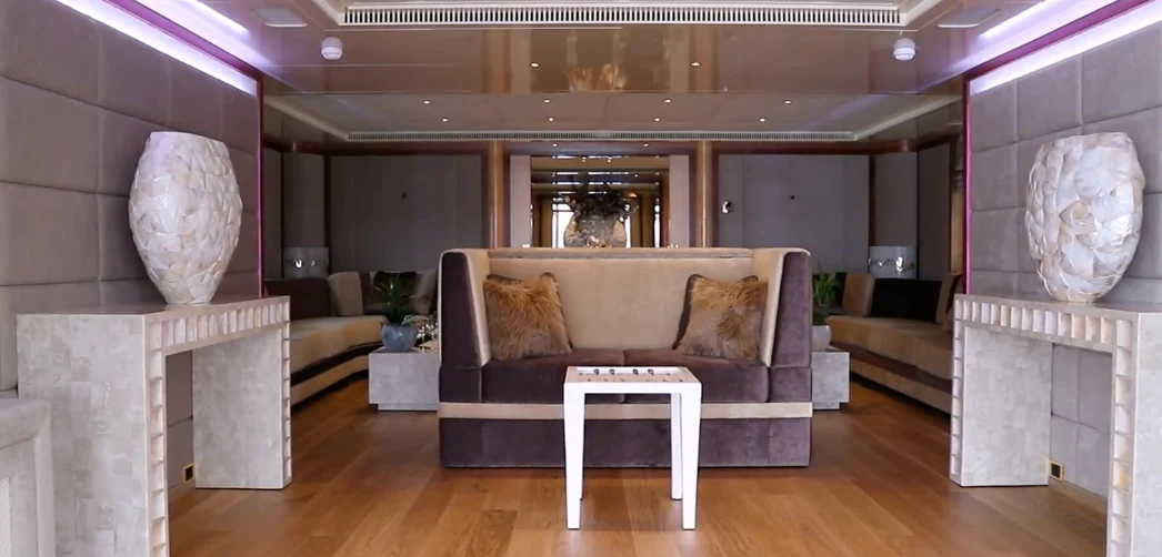 a living room with a couch and a large mirror aboard ANNA J Yacht for Sale