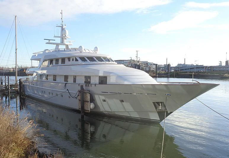 a large white boat in a harbor aboard ANNA J Yacht for Sale