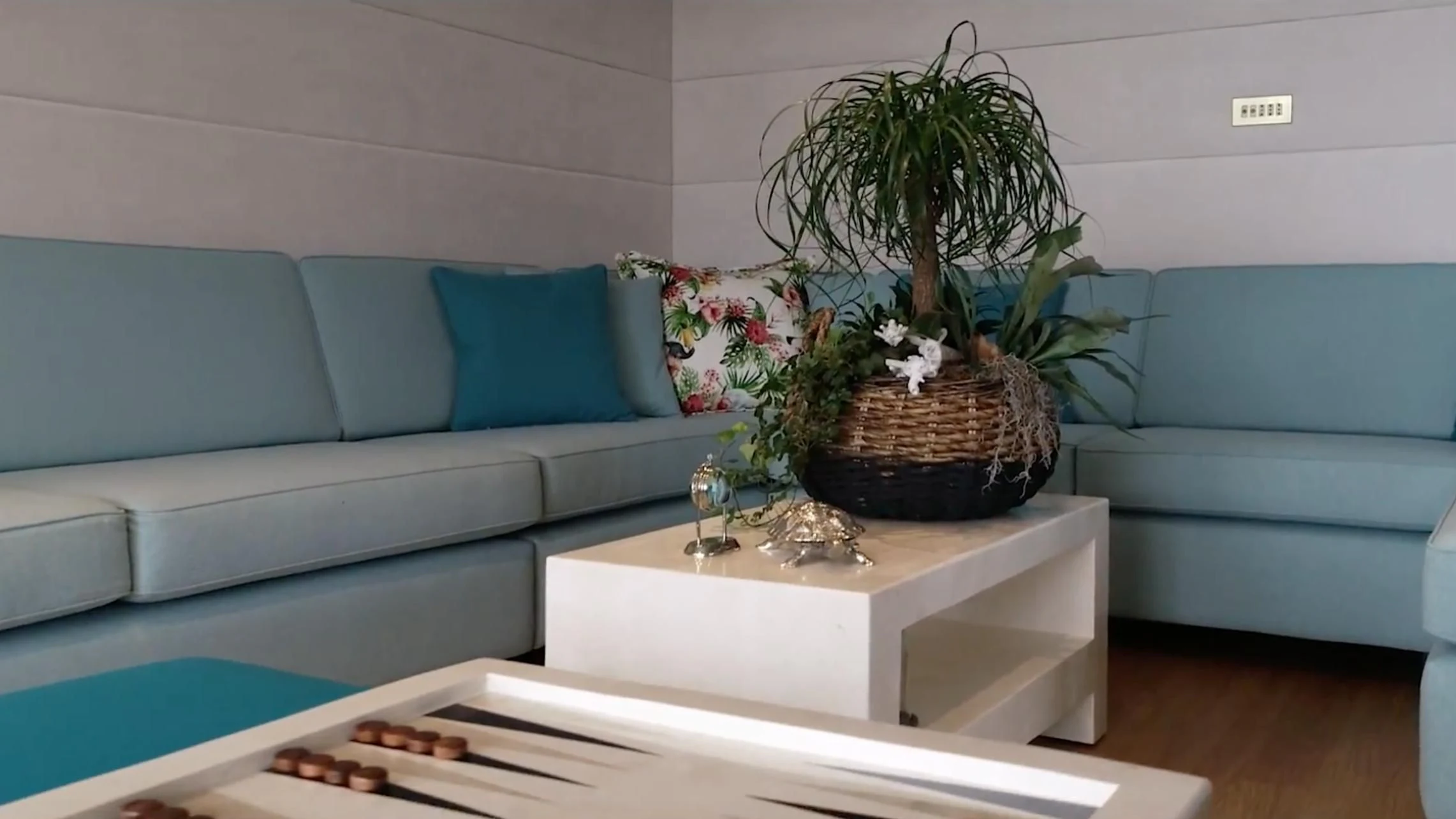 a plant in a pot on a table in a living room aboard ANNA J Yacht for Sale