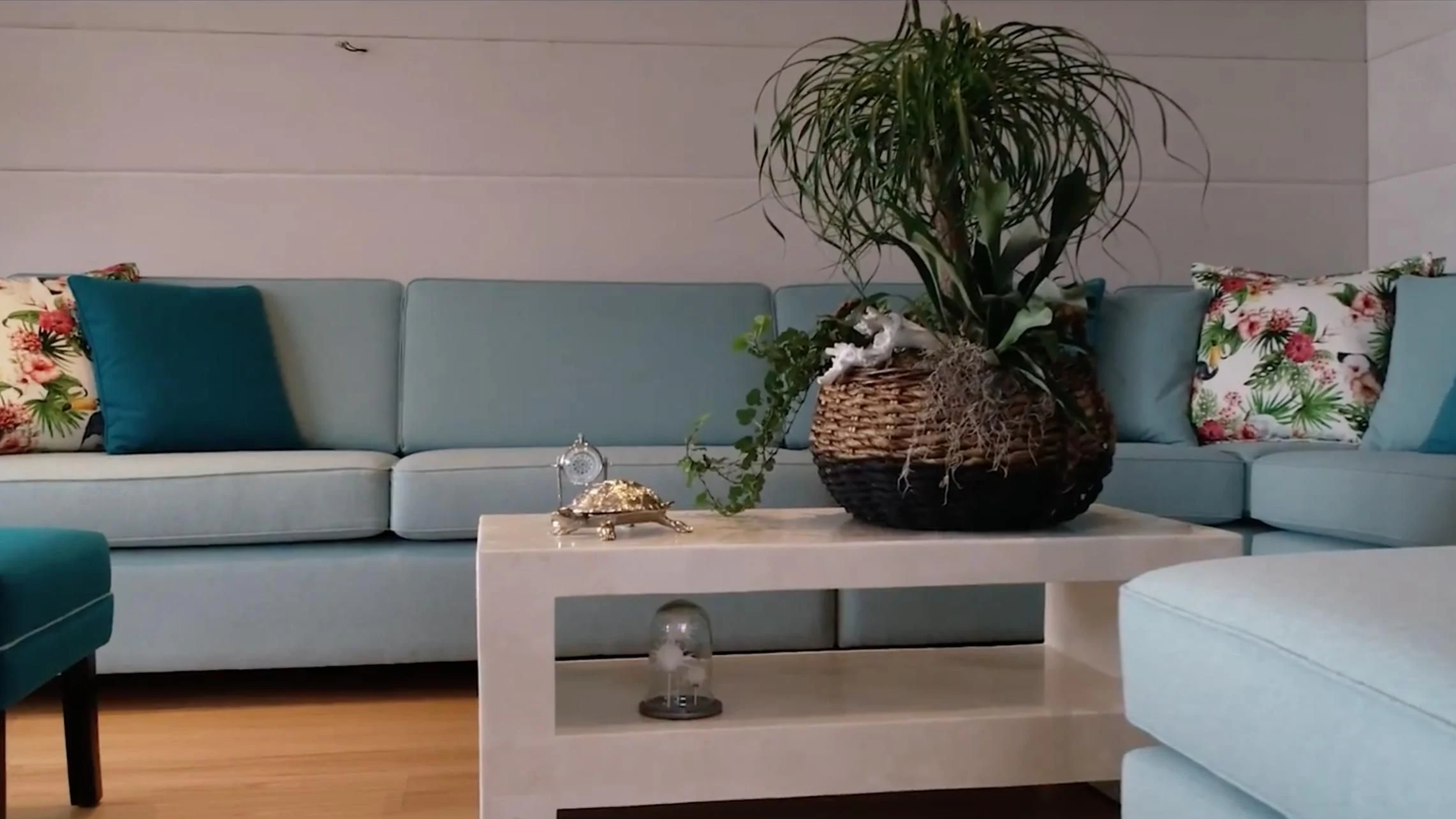 a white coffee table with a plant in a glass vase on top aboard ANNA J Yacht for Sale
