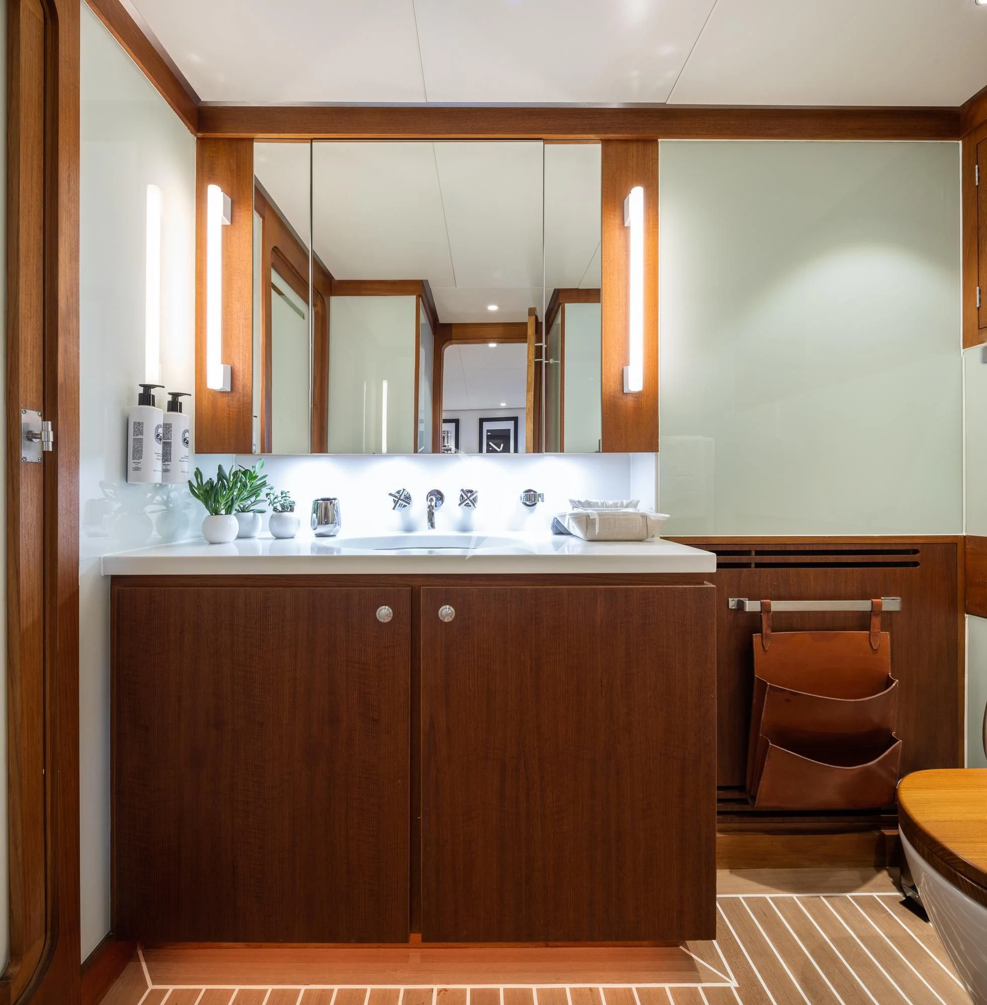 a kitchen with wooden cabinets aboard CURIOSITY Yacht for Sale