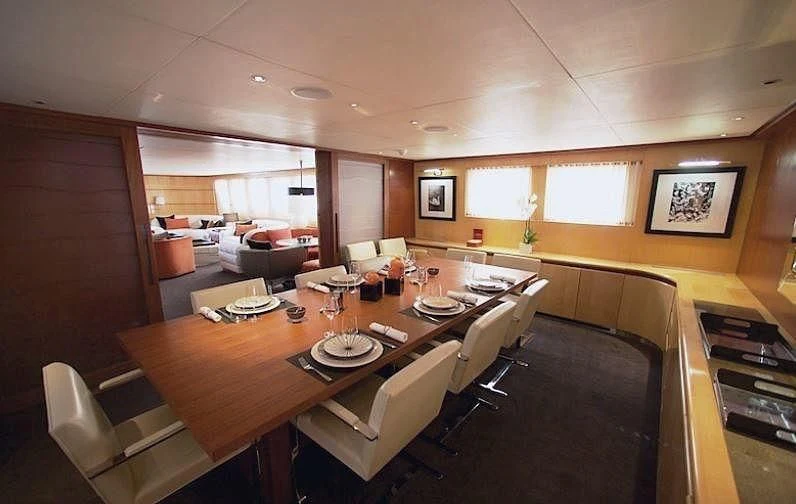 a dining room with a table and chairs aboard CURIOSITY Yacht for Sale