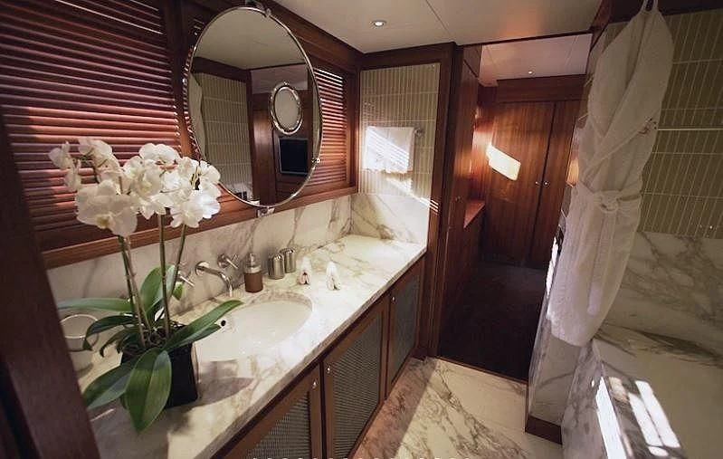 a bathroom with a large mirror aboard CURIOSITY Yacht for Sale