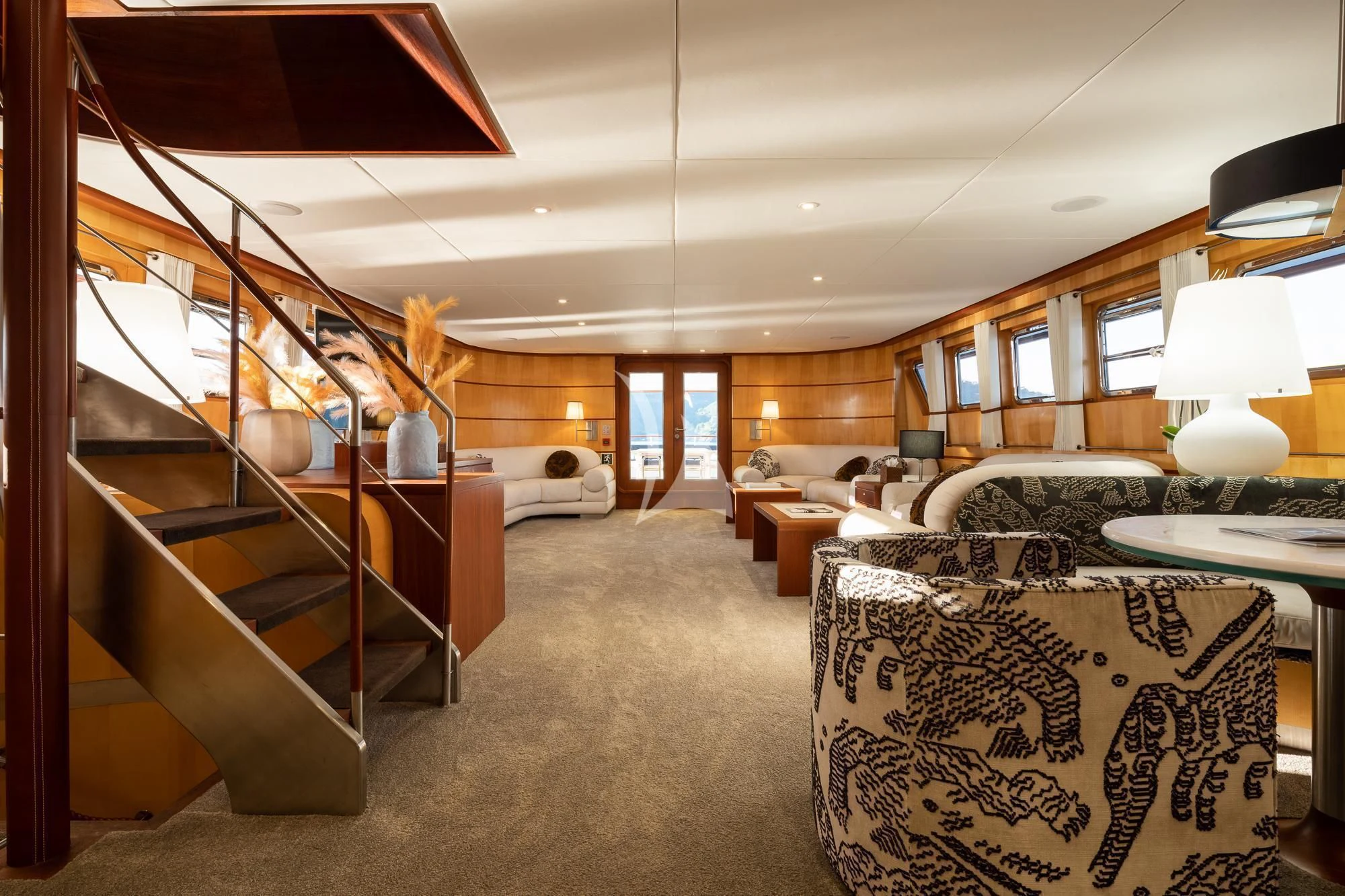 a living room with a staircase aboard CURIOSITY Yacht for Sale