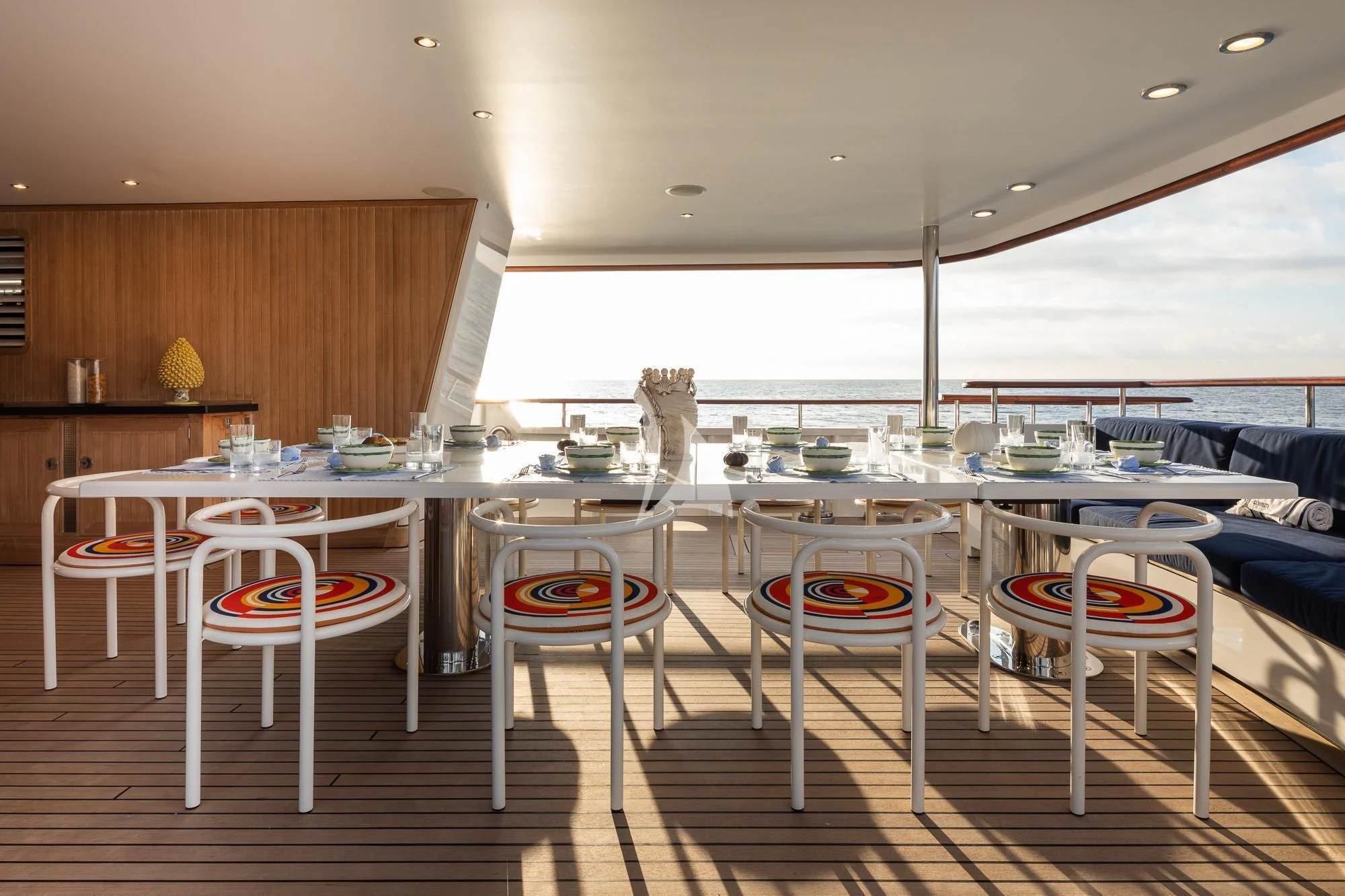 a room with tables and chairs aboard CURIOSITY Yacht for Sale