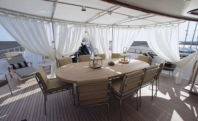 a large tent with a table and chairs aboard CURIOSITY Yacht for Sale