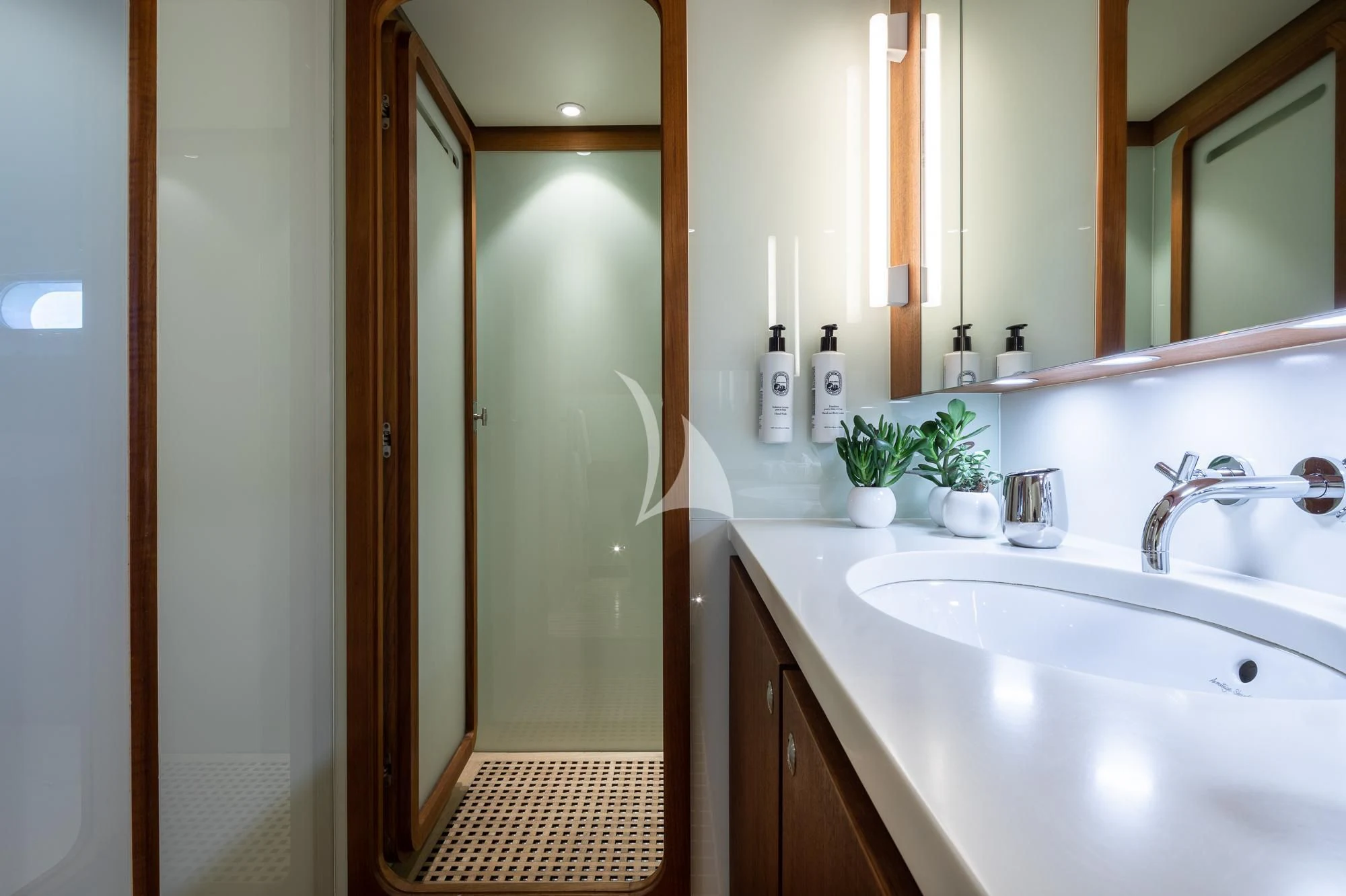 a bathroom with a sink and a mirror aboard CURIOSITY Yacht for Sale