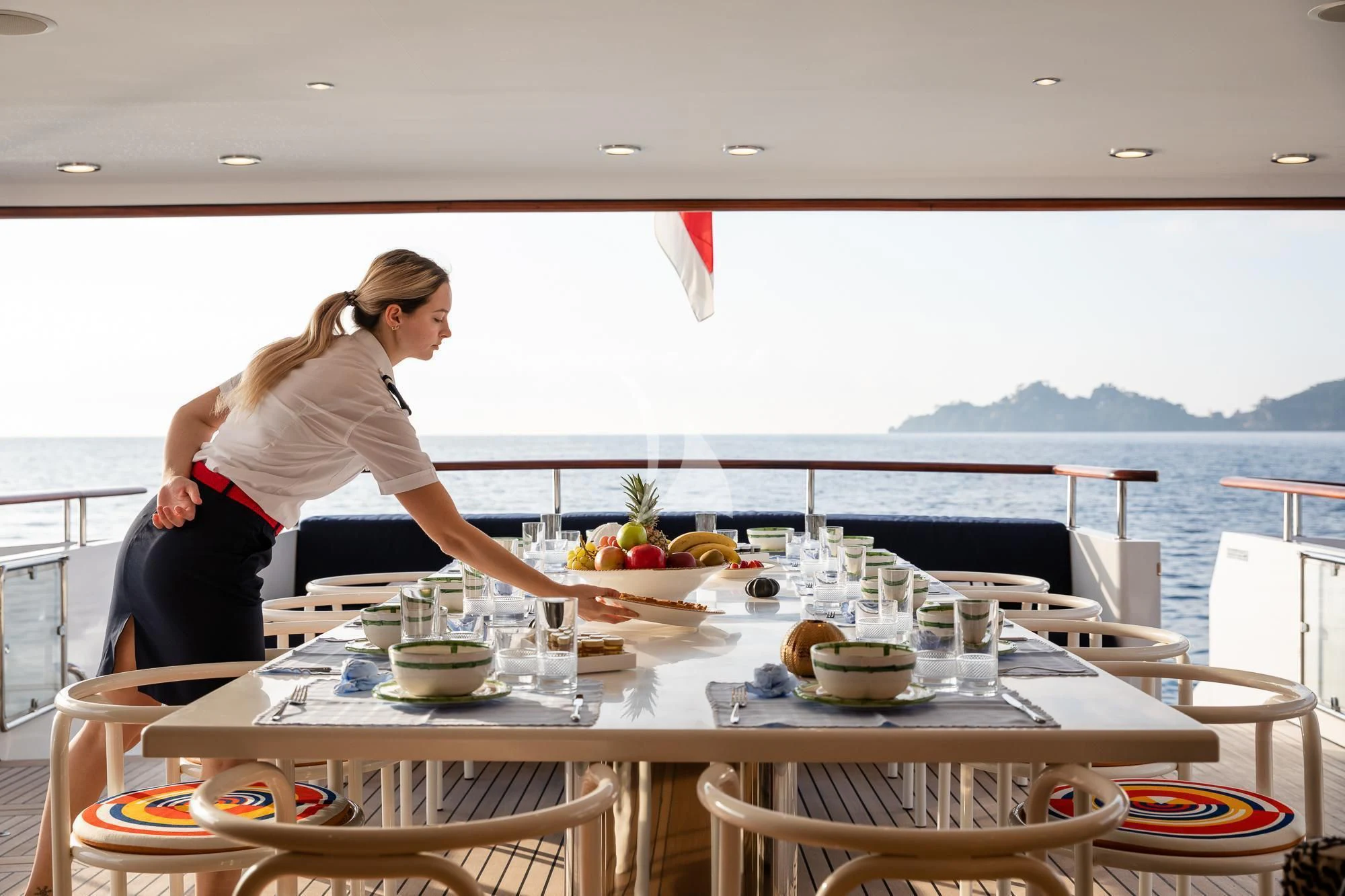 a person sitting at a table aboard CURIOSITY Yacht for Sale