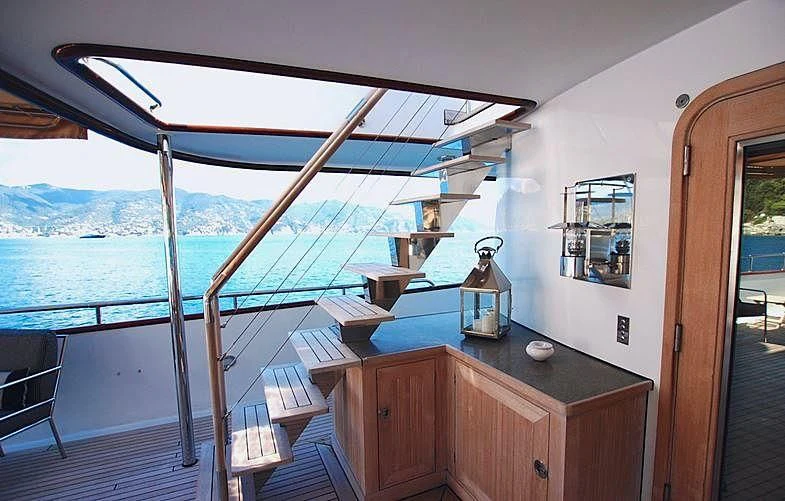 a balcony overlooking a body of water aboard CURIOSITY Yacht for Sale