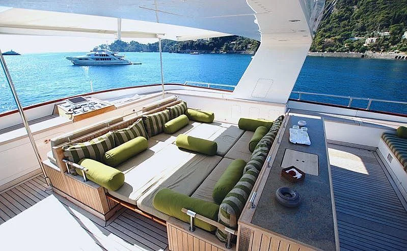 a deck with a boat and a dock and a large body of water aboard CURIOSITY Yacht for Sale