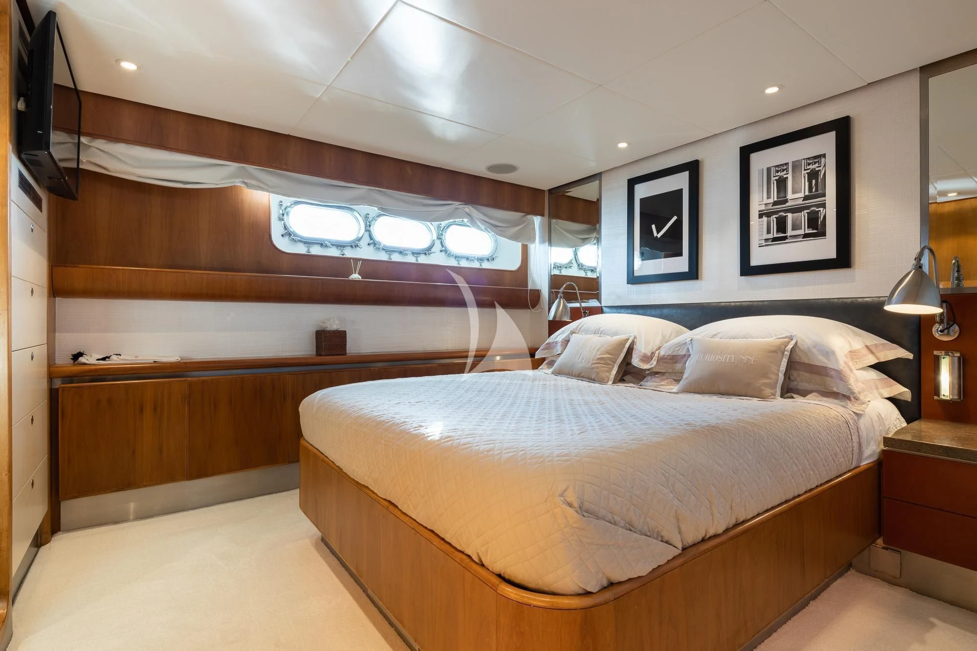 a room with a bed and a television aboard CURIOSITY Yacht for Sale
