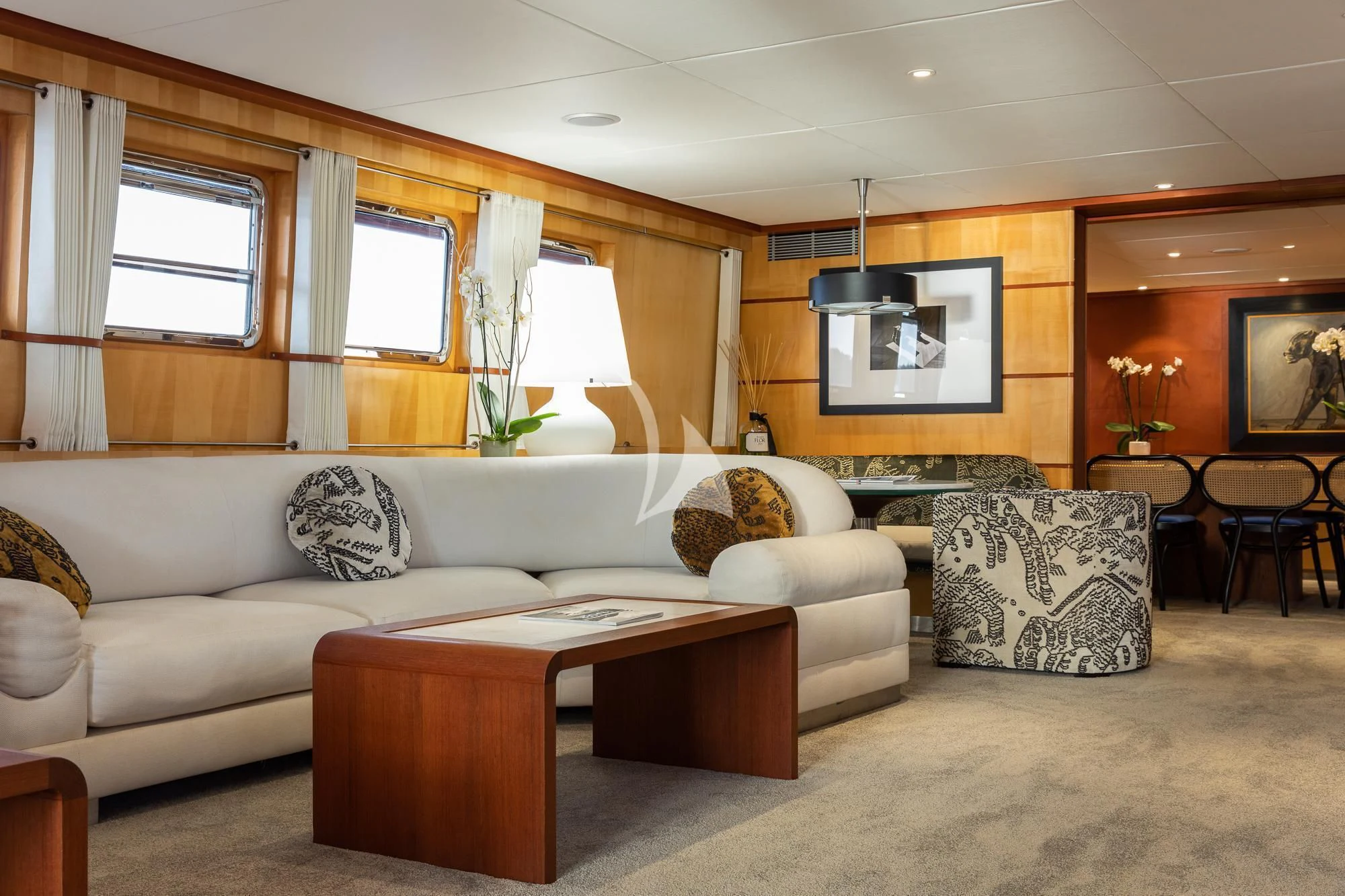 a living room with a couch and a table aboard CURIOSITY Yacht for Sale