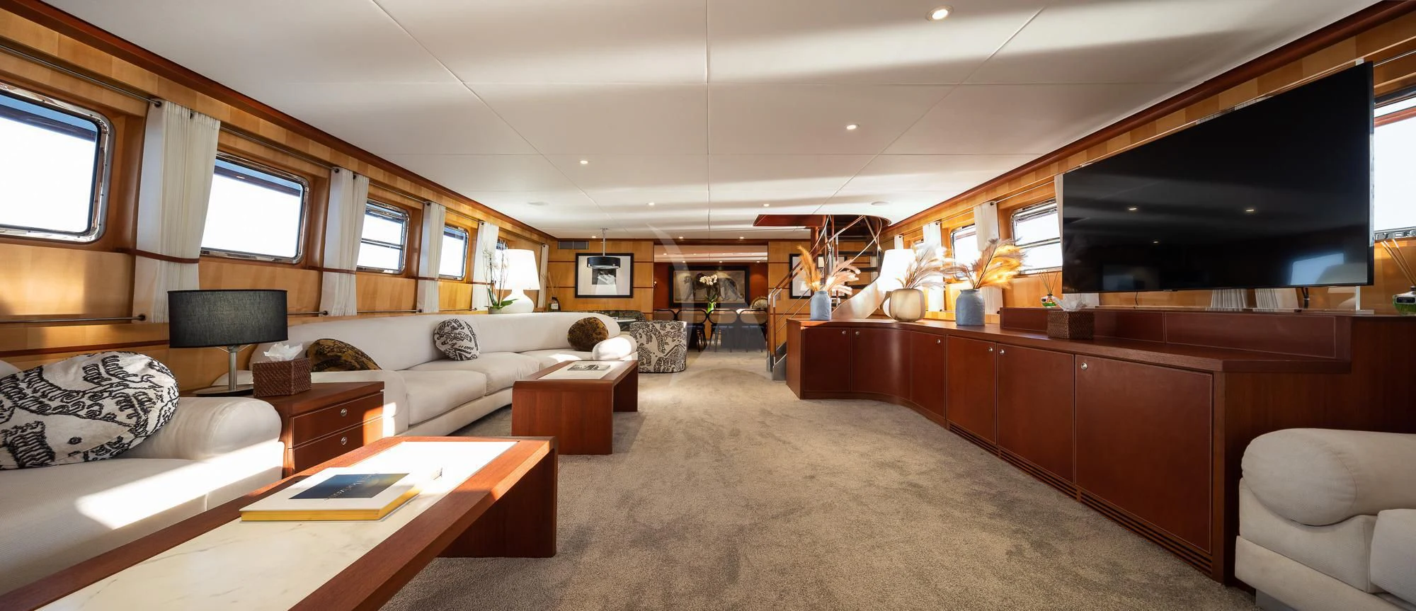 a living room with a large television aboard CURIOSITY Yacht for Sale