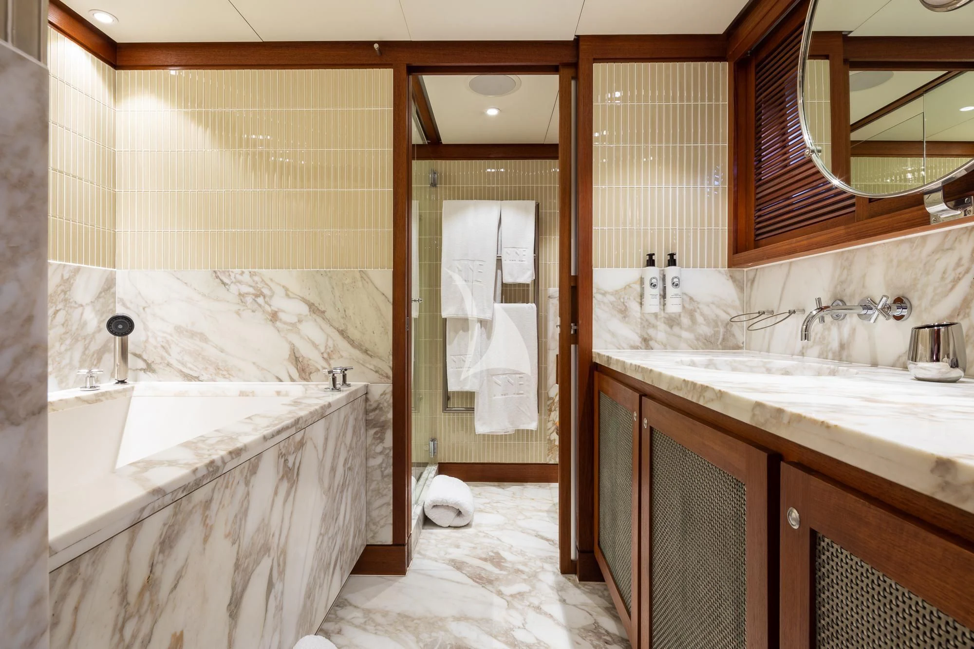 a bathroom with a tub sink and a sink aboard CURIOSITY Yacht for Sale