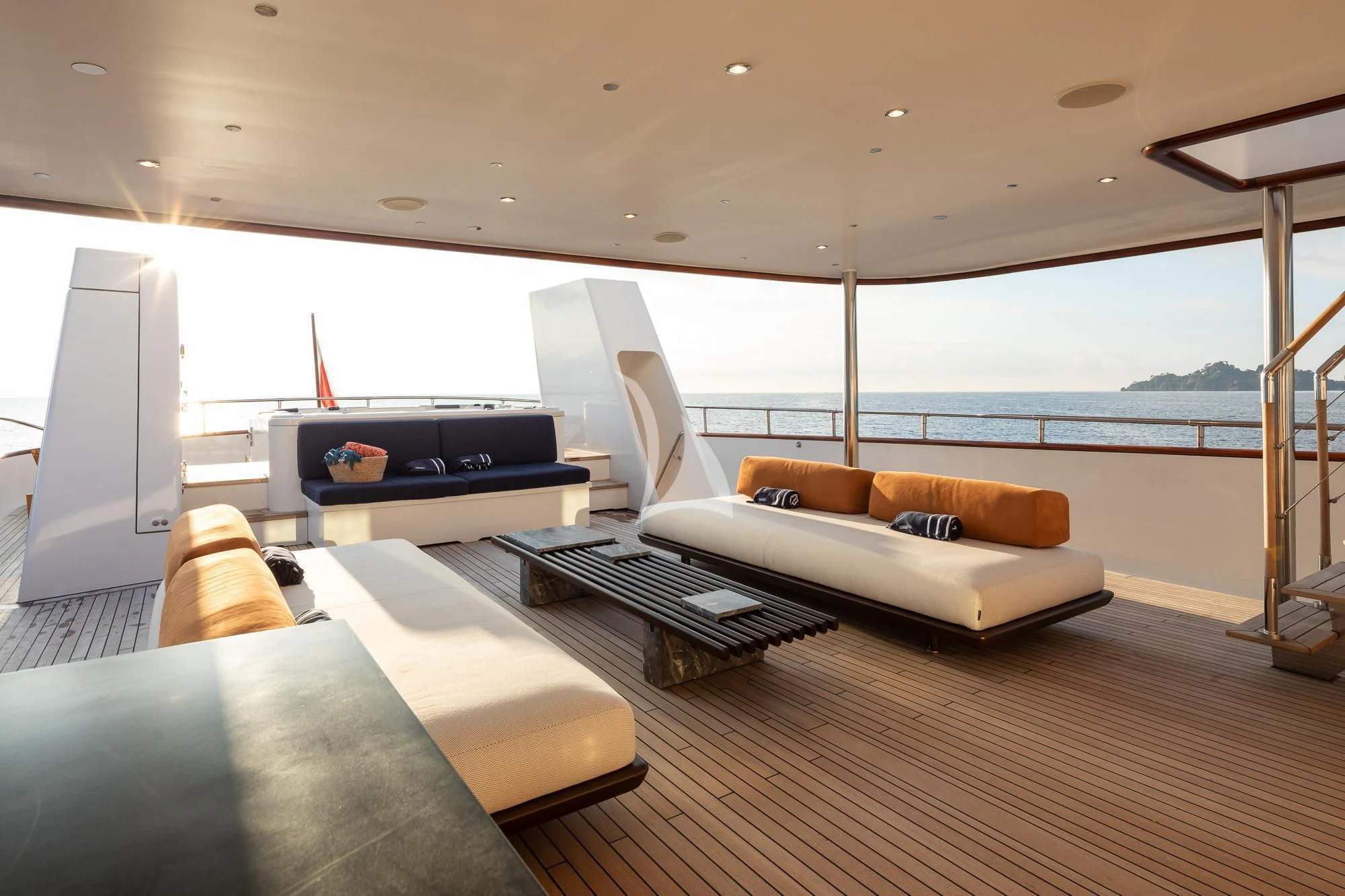 a living room with a large balcony aboard CURIOSITY Yacht for Sale