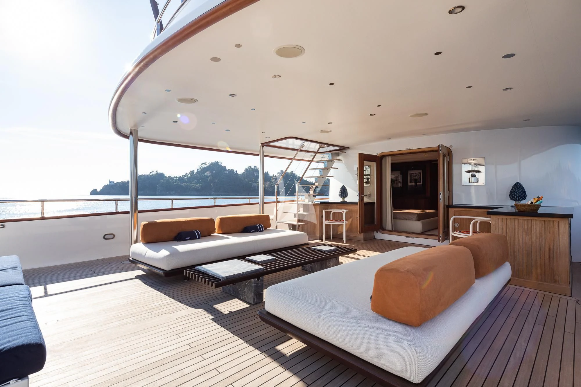 a room with a bed and a table aboard CURIOSITY Yacht for Sale