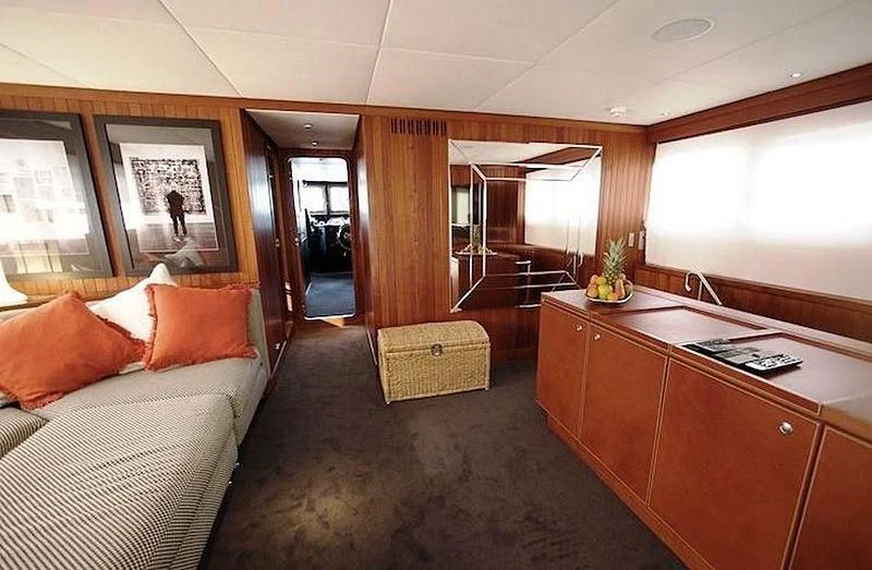 a room with a bed and desk aboard CURIOSITY Yacht for Sale