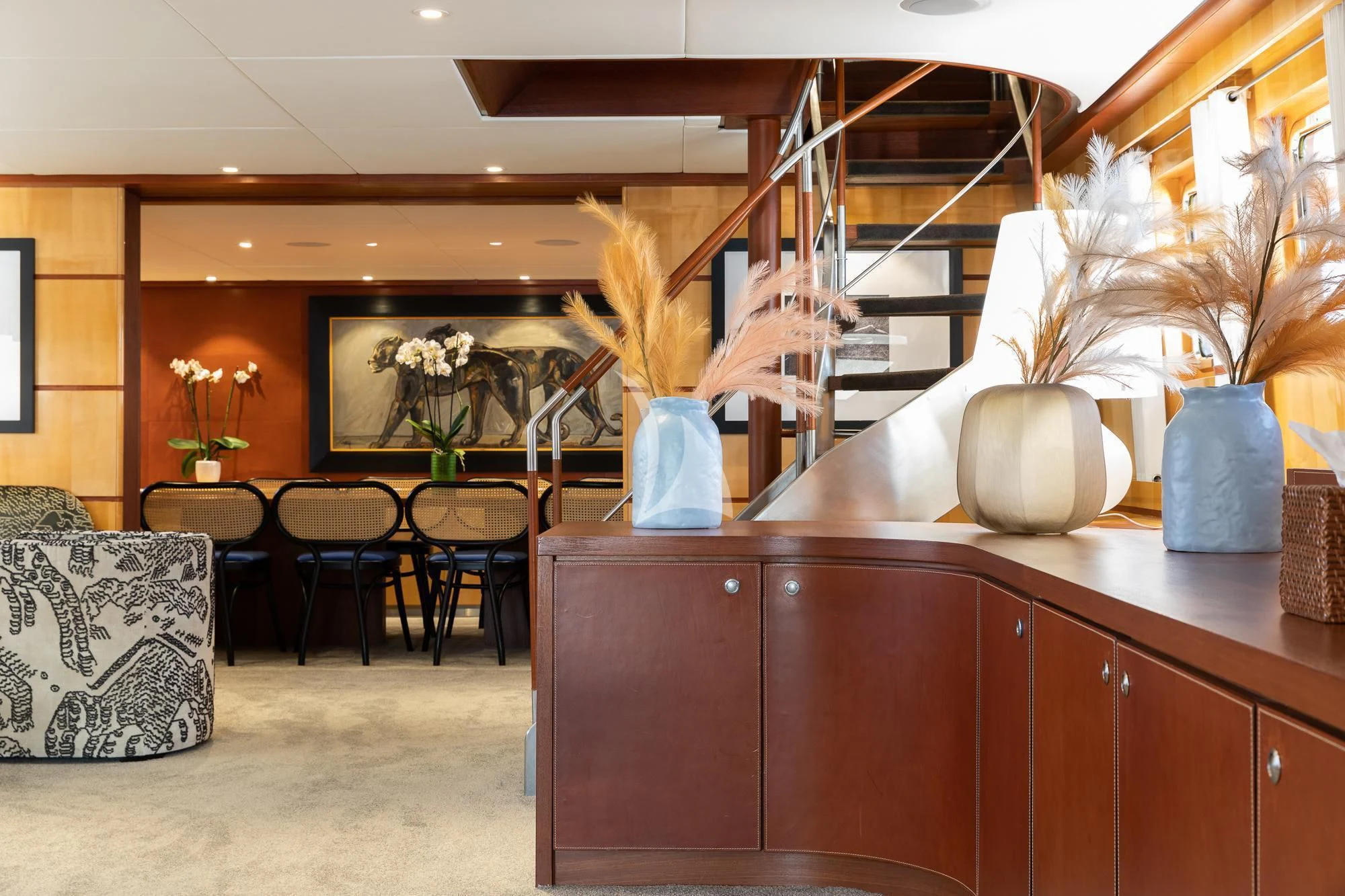 a room with a desk and chairs aboard CURIOSITY Yacht for Sale